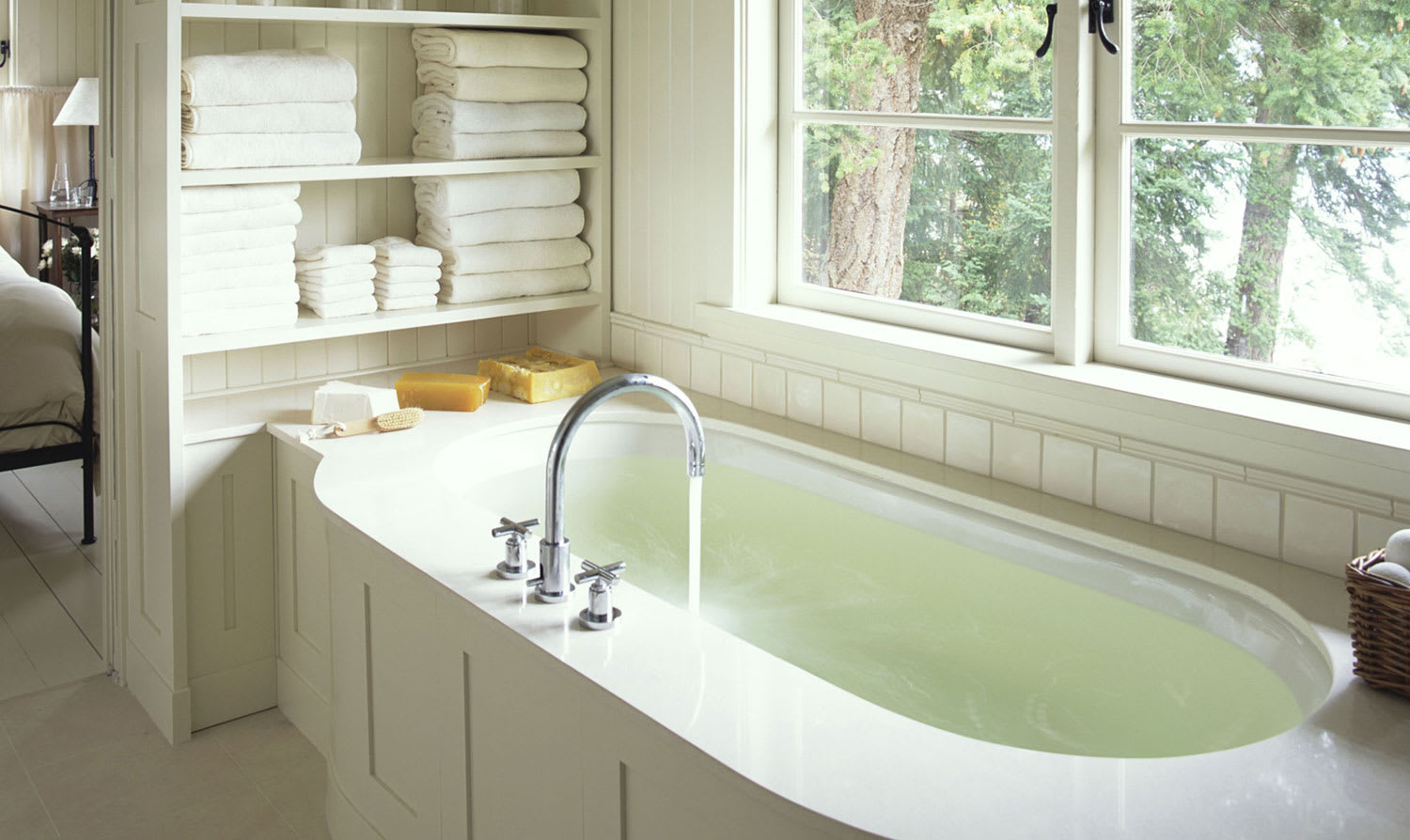 Water running in bathtub with white paneling