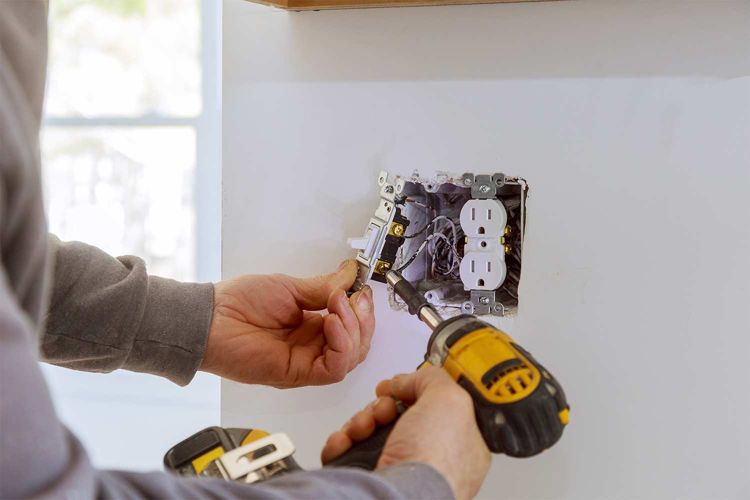 Electrician fixing an outlet