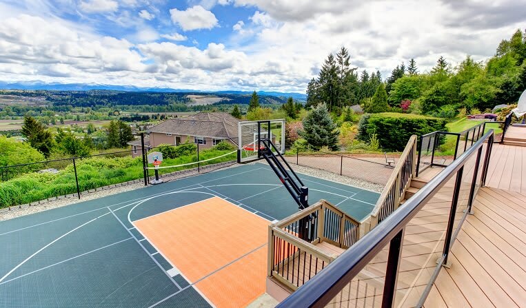 basketball court off backyard deck on a residential property in the mountains