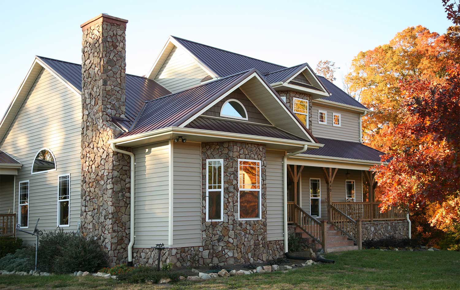 Beige house with new metal roof
