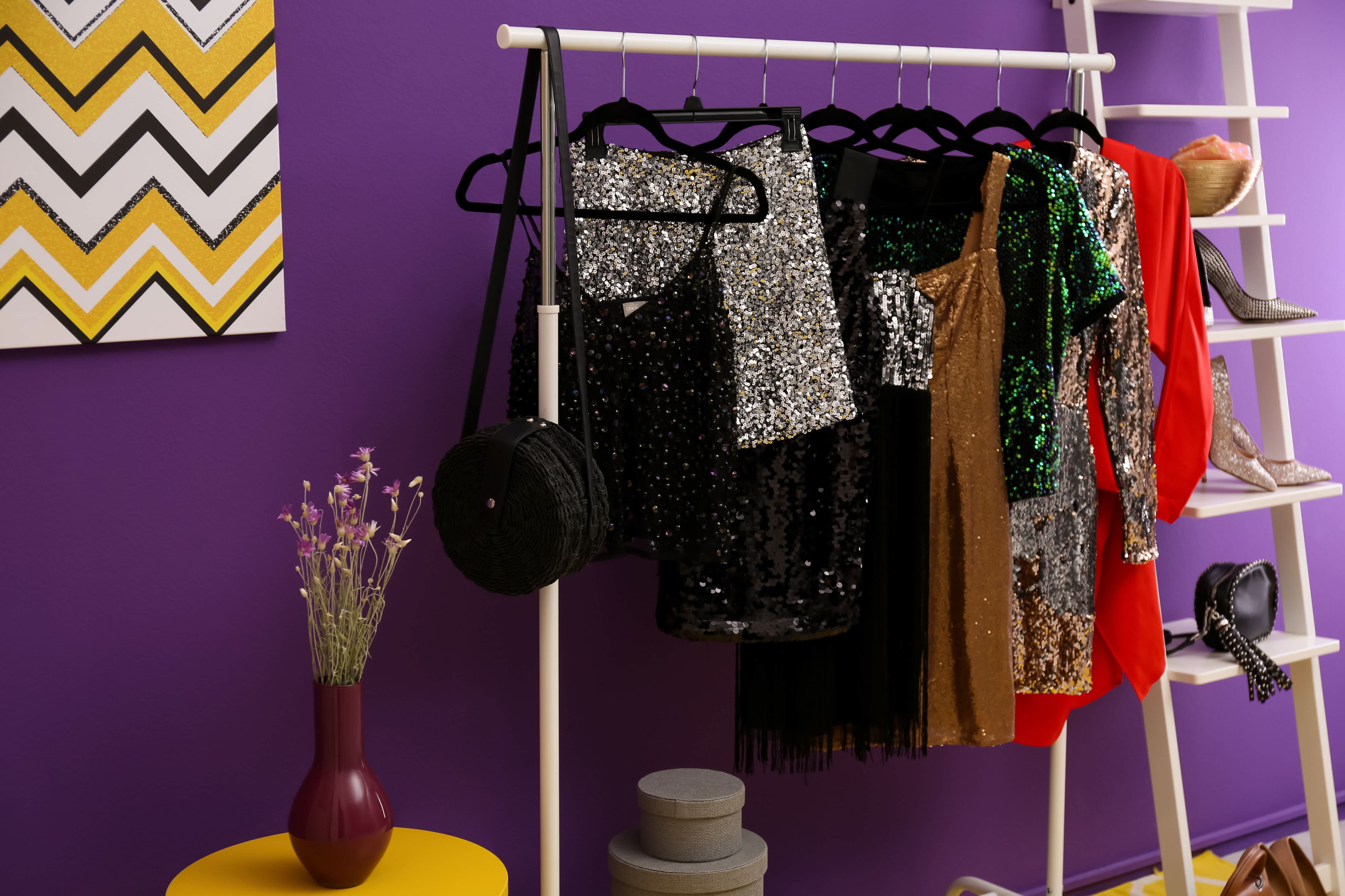 A clothing rack with vibrant colors and a ladder shelf for shoes