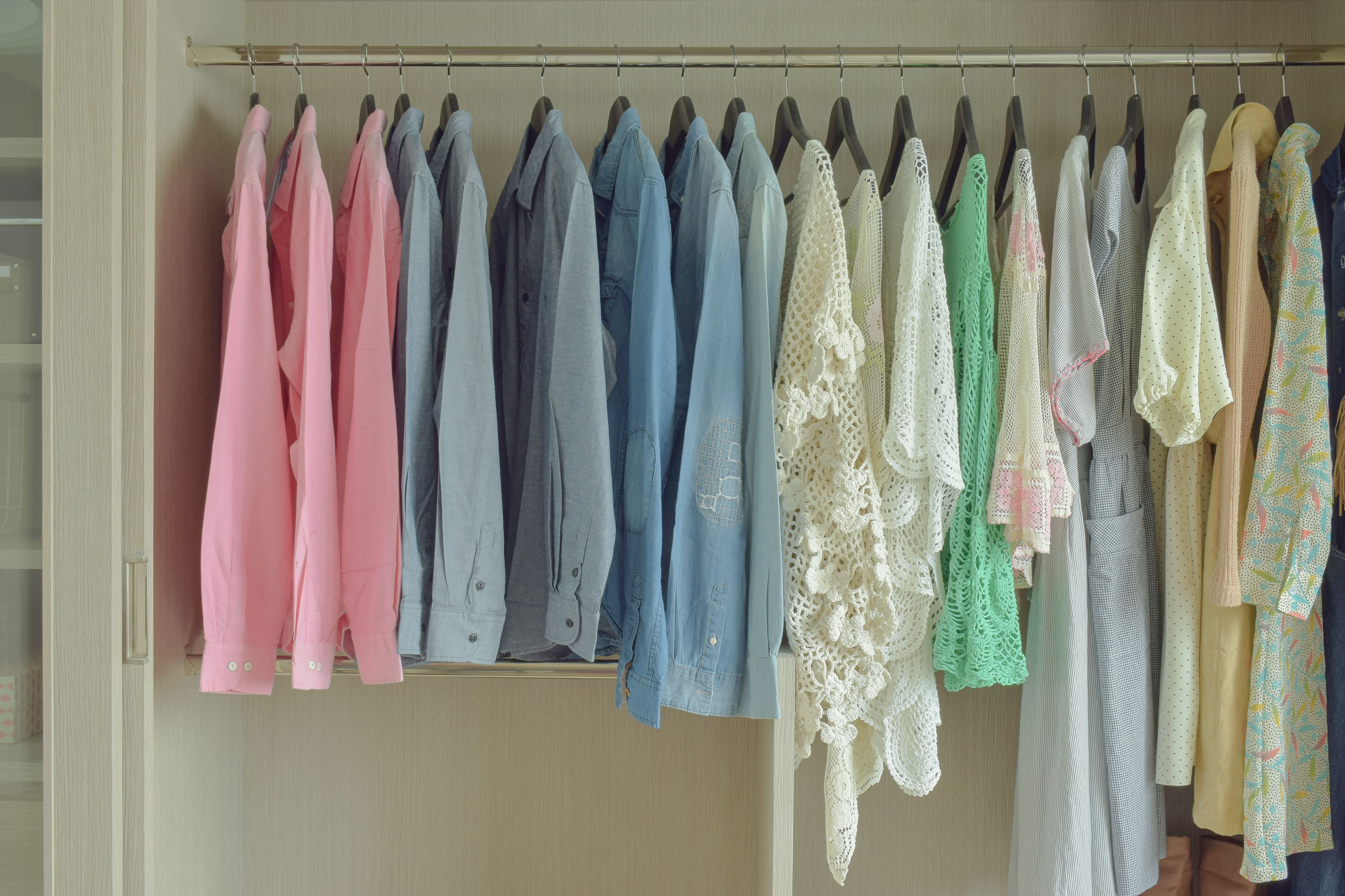 Hanging clothes organized by color