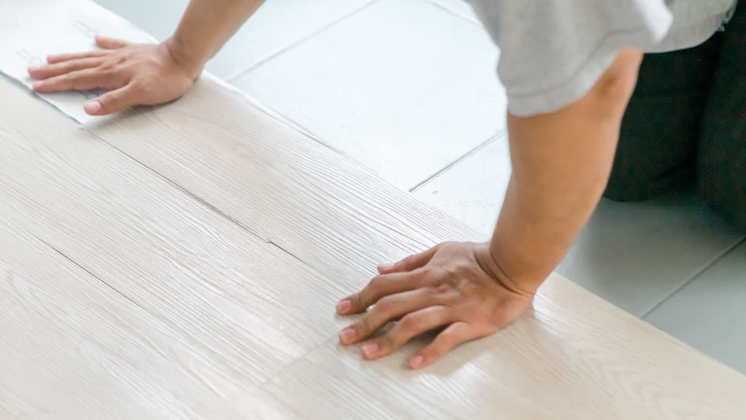 Detail of a professional installing vinyl flooring
