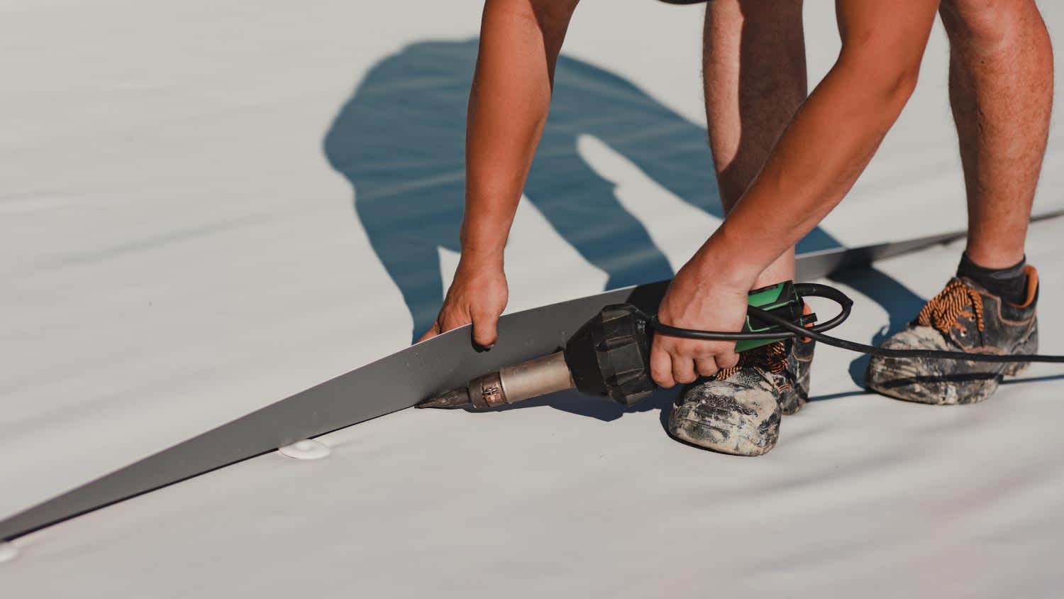 Worker welding pvc roof membrane