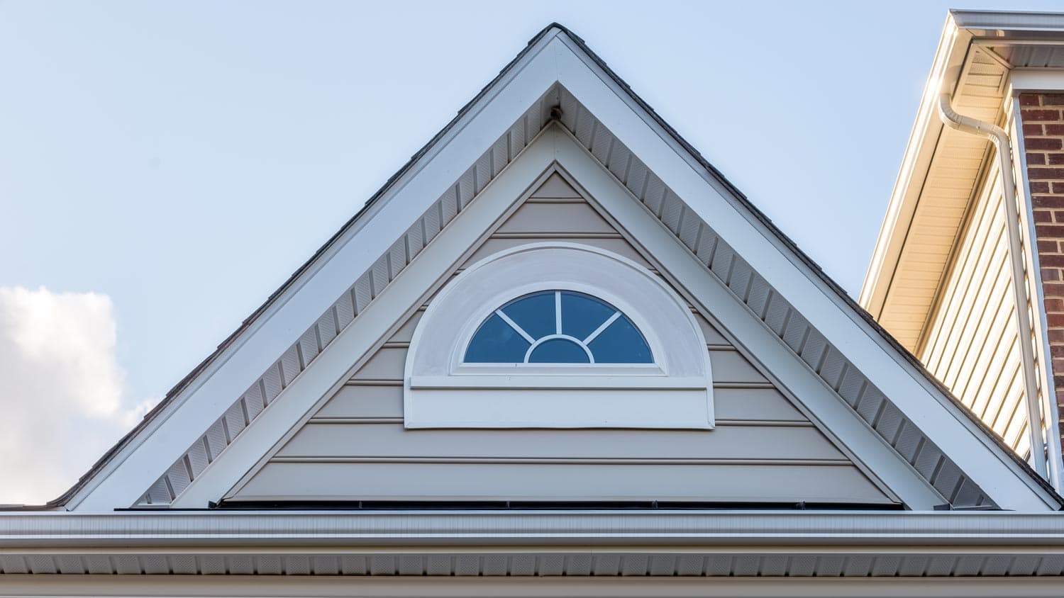 A house with an attic window and vinyl soffit