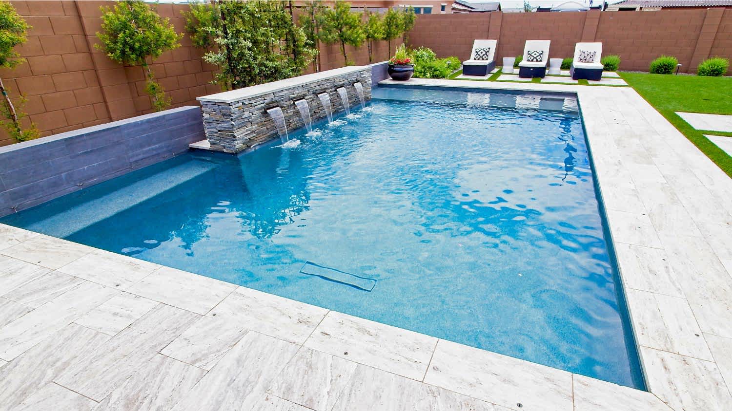 Outdoor swimming pool with three lounge couches