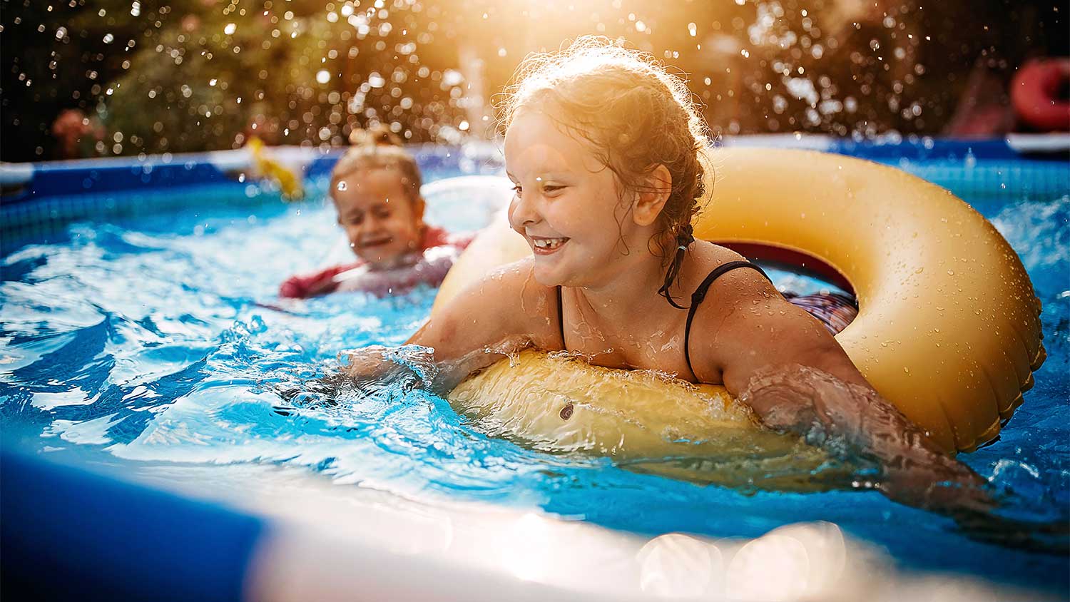 Children play in an above ground pool