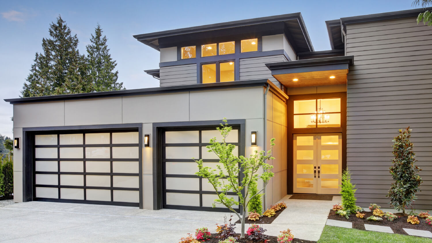 contemporary garage doors on modern house in the evening