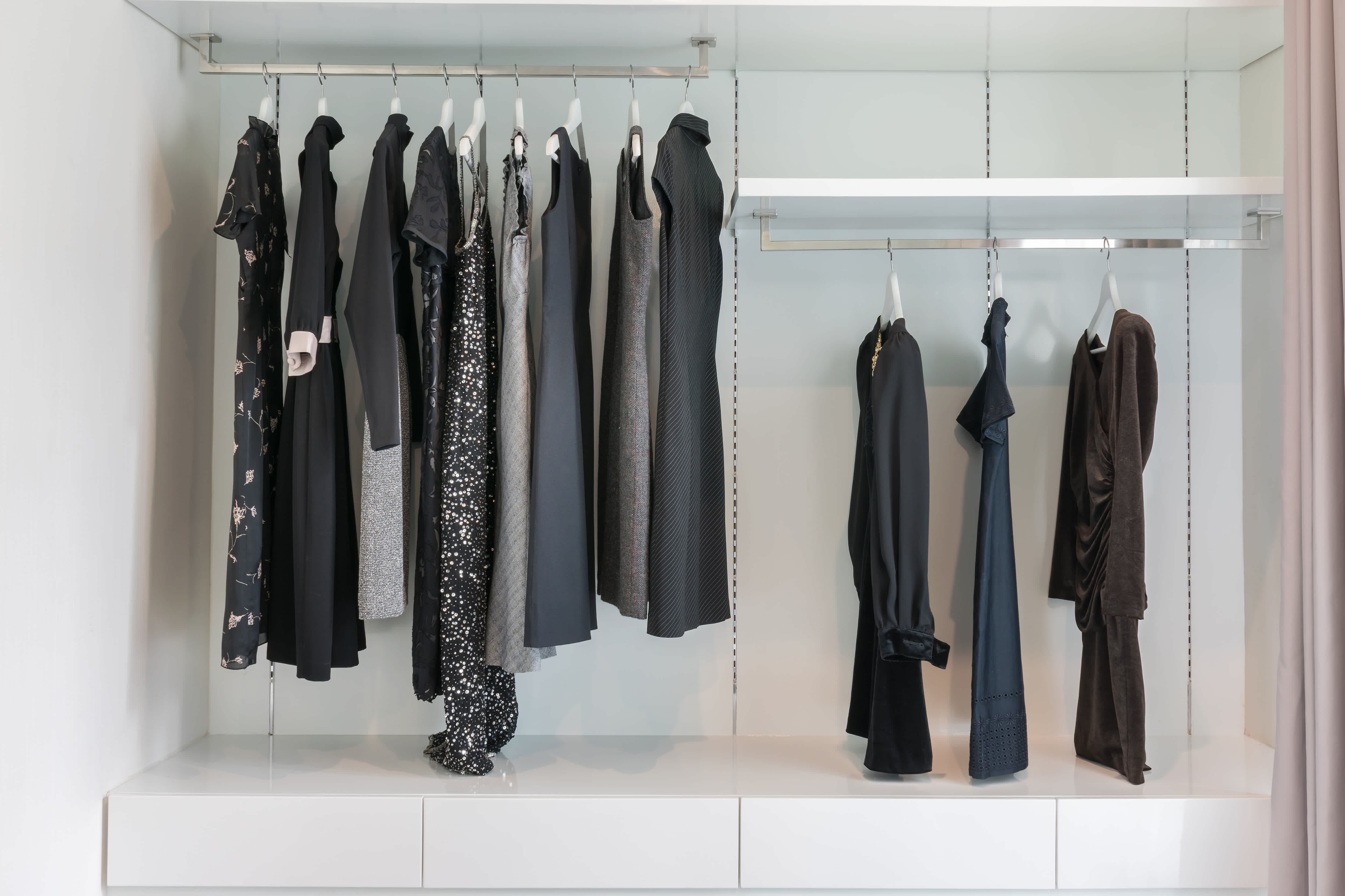A small closet with two closet rods at different levels