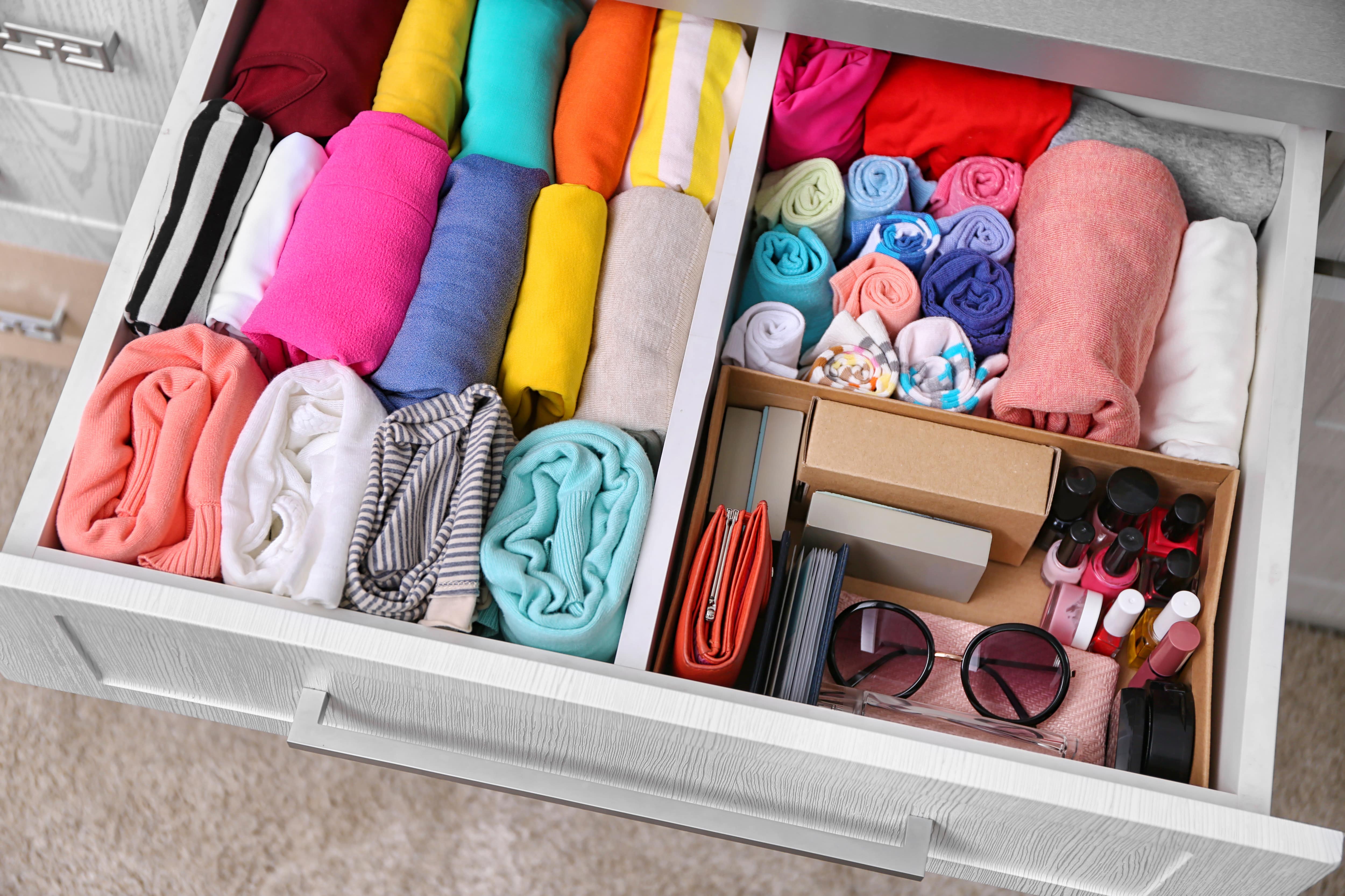 A neatly organized dresser drawer with internal dividers