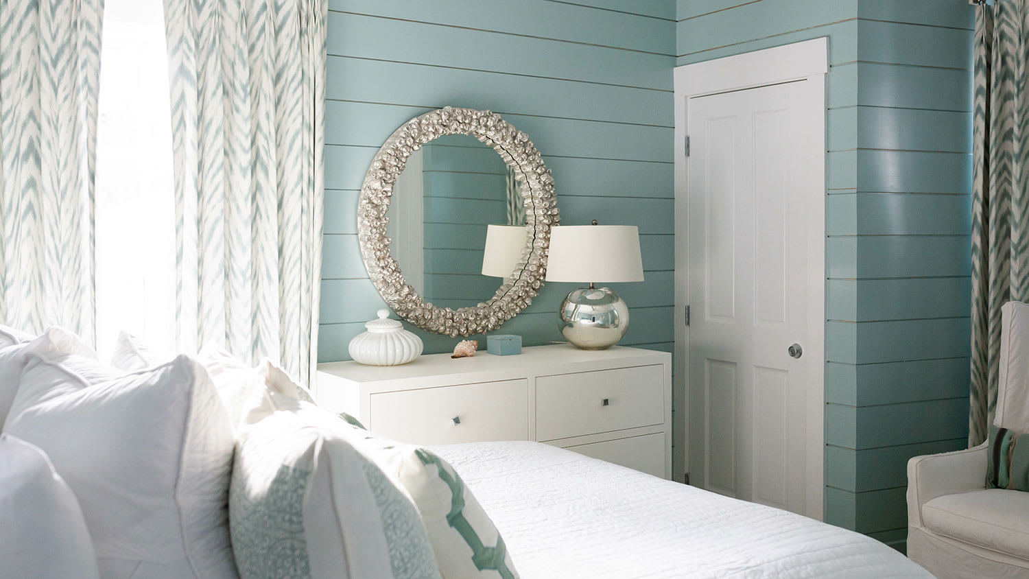 Beach house bedroom with shiplap walls