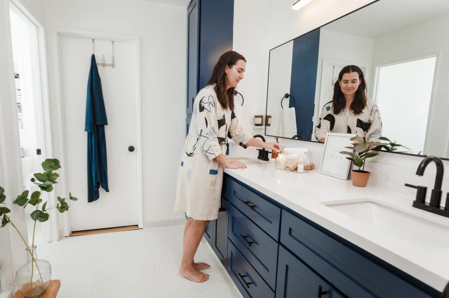 woman in white and navy bathroom