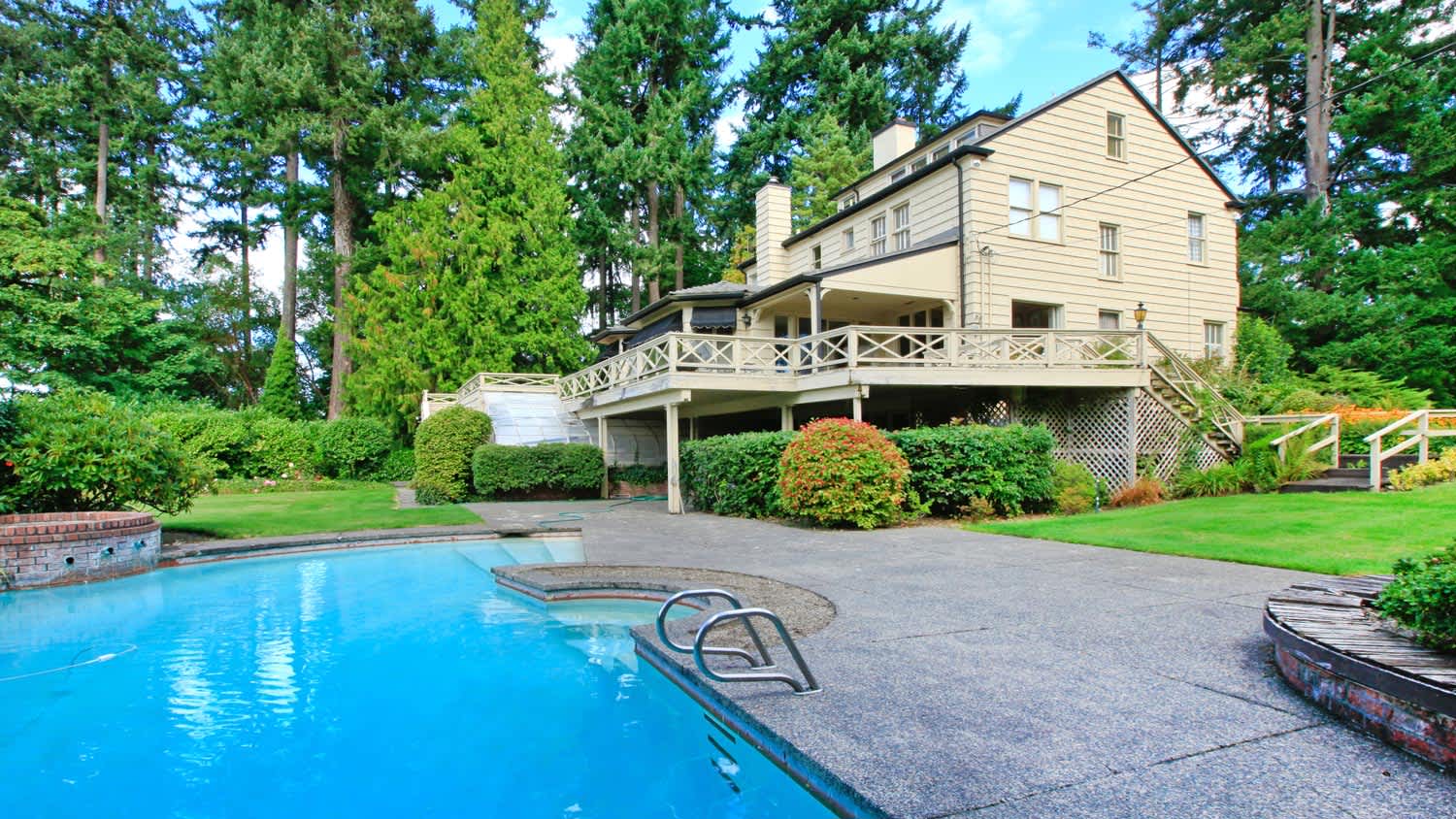 A house with a large garden and a swimming pool