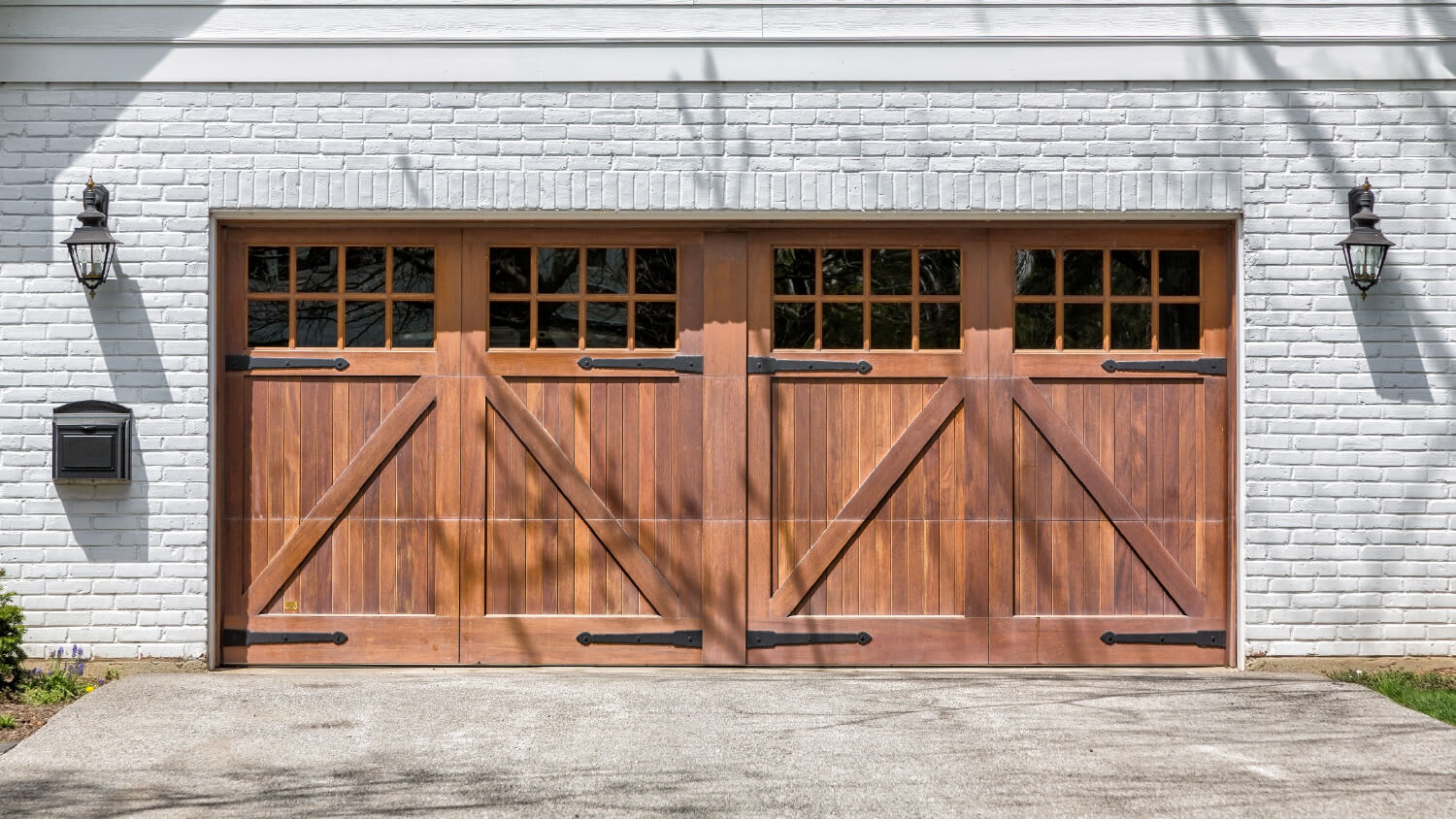 wooden double garage doors with white brick