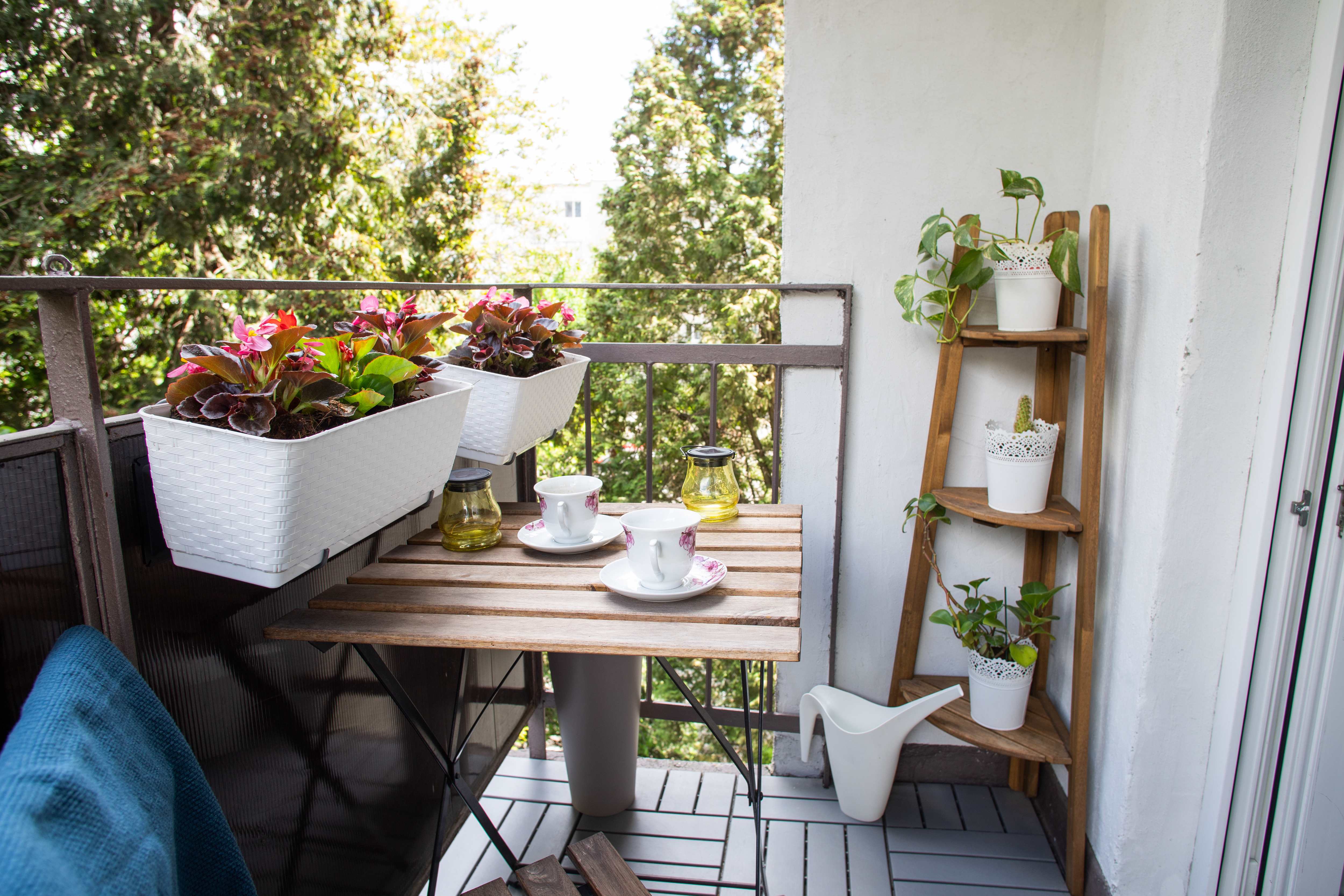 Wooden corner shelf unit on small balcony