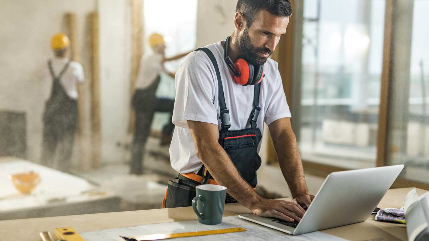 A contractor using his laptop on a construction site