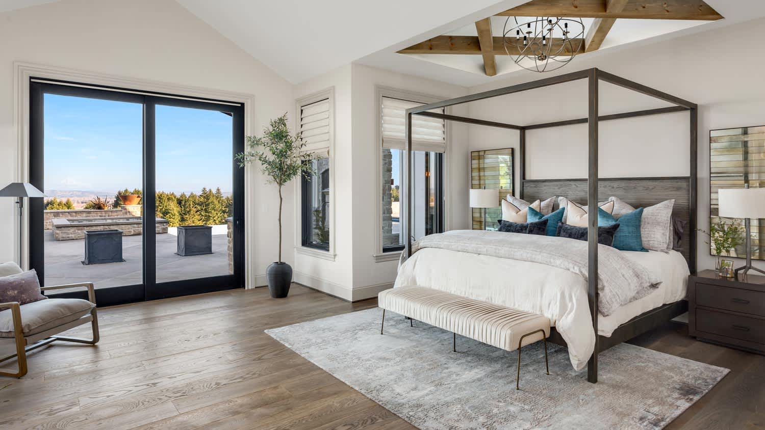 A large bedroom with glass sliding doors leading to a patio