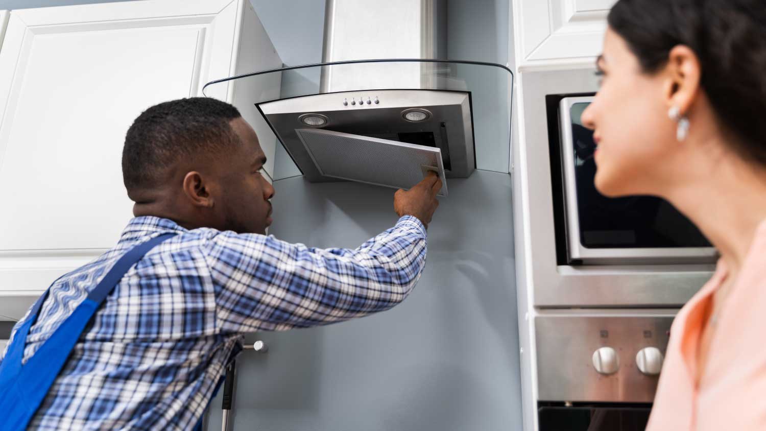 man fixing oven