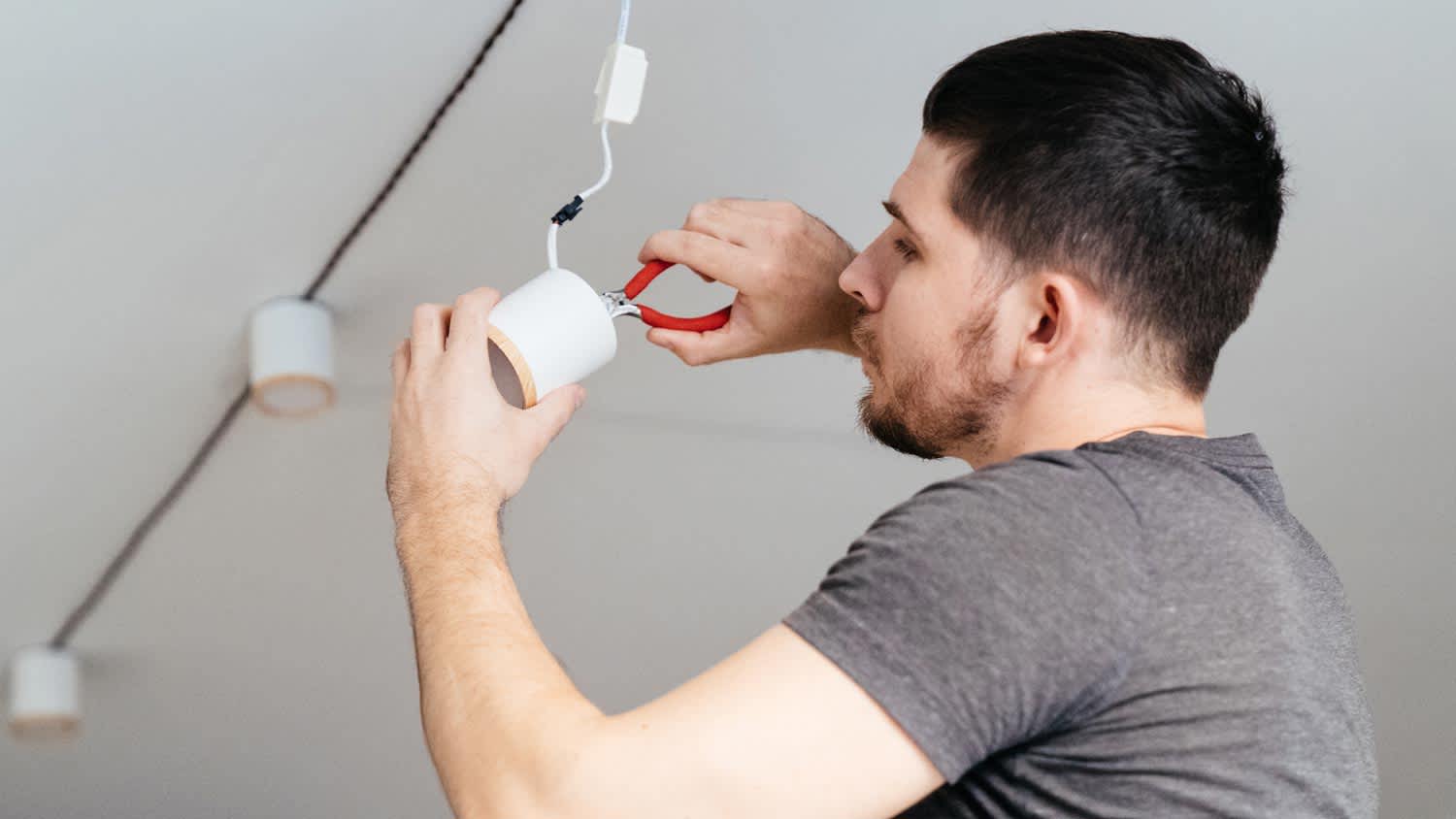 A man installing a new lighting fixture