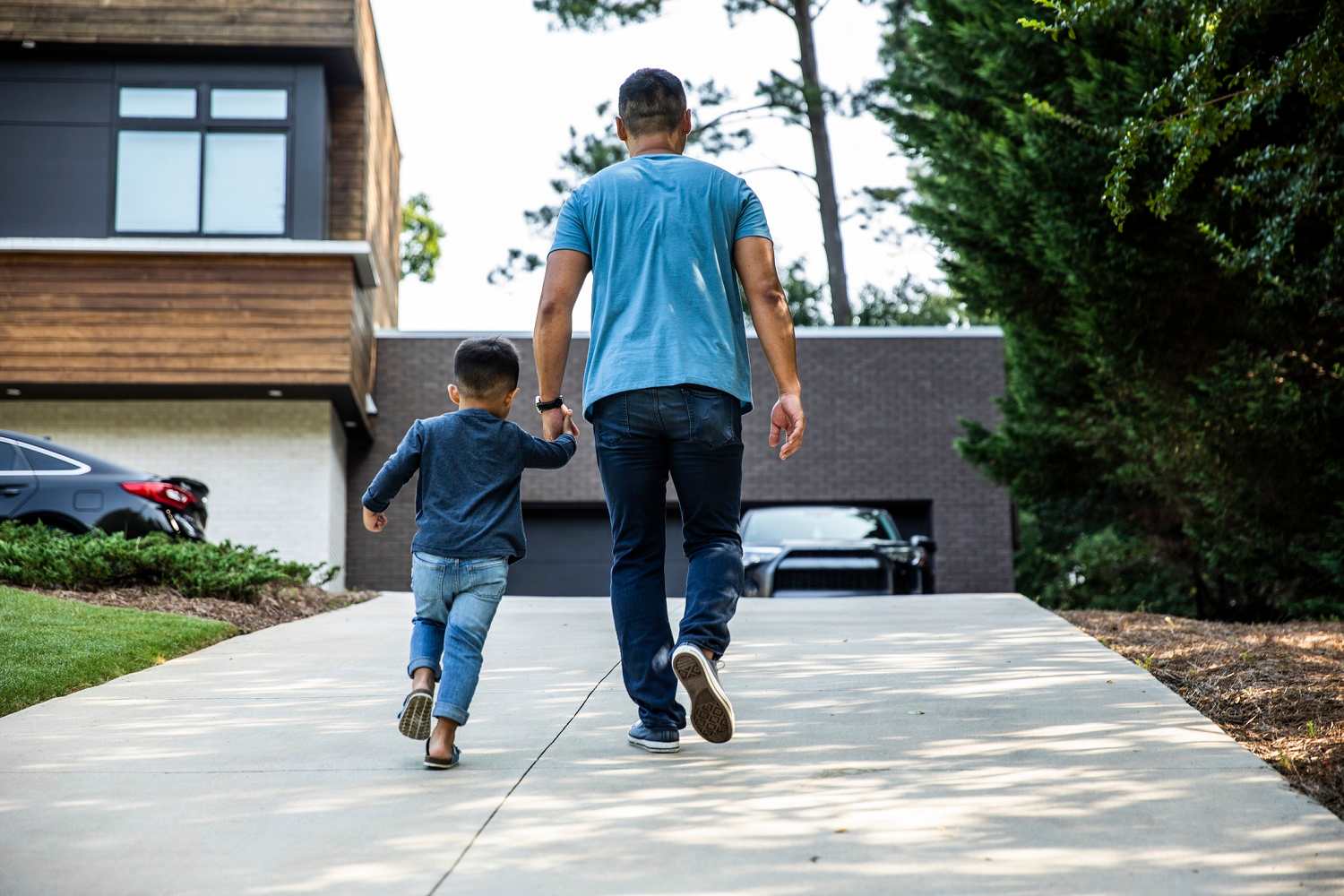 Father and son walk up driveway