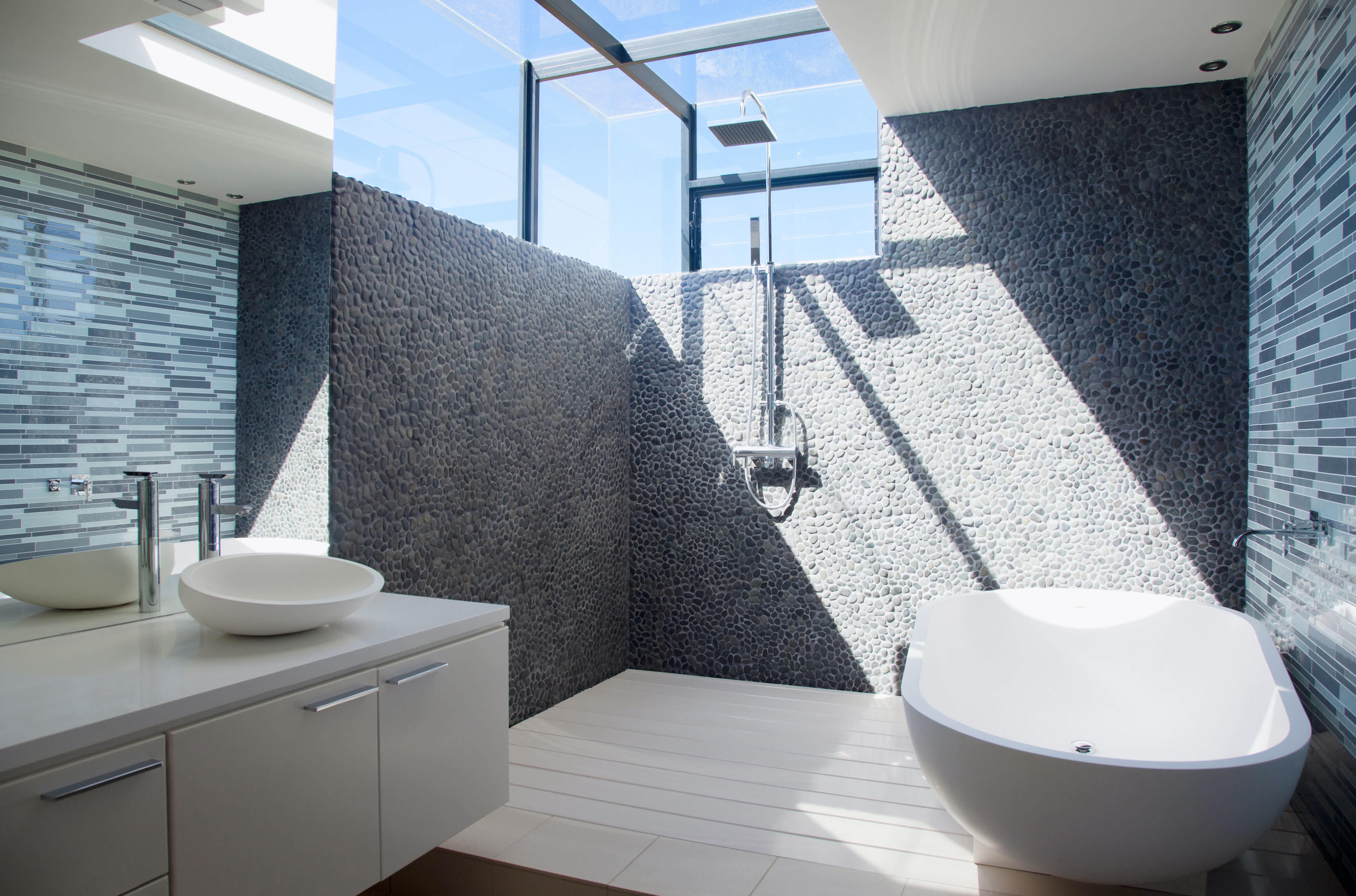 A curbless bathroom with shower, bathtub, and sink