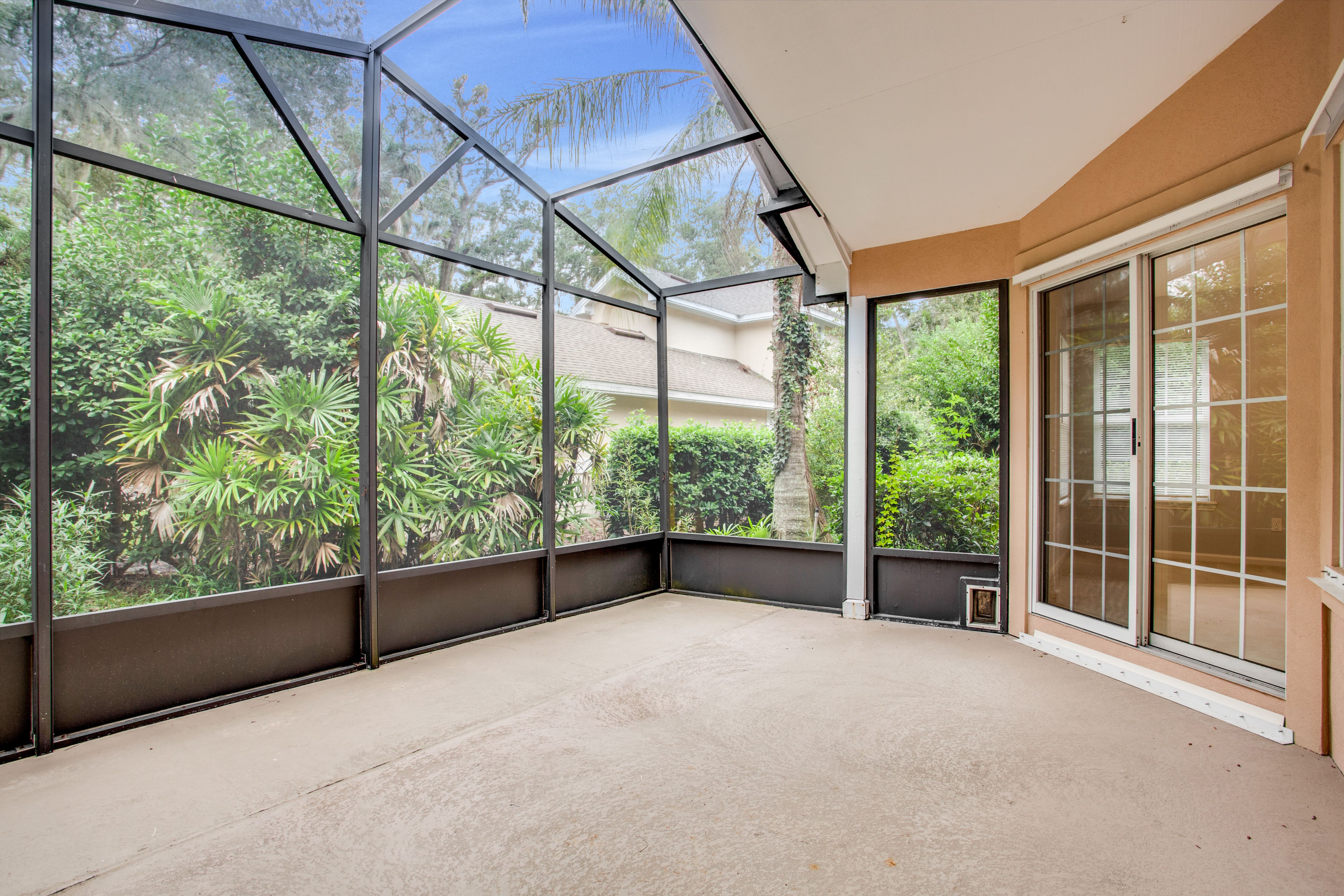 Large screened-in porch on the back of the home