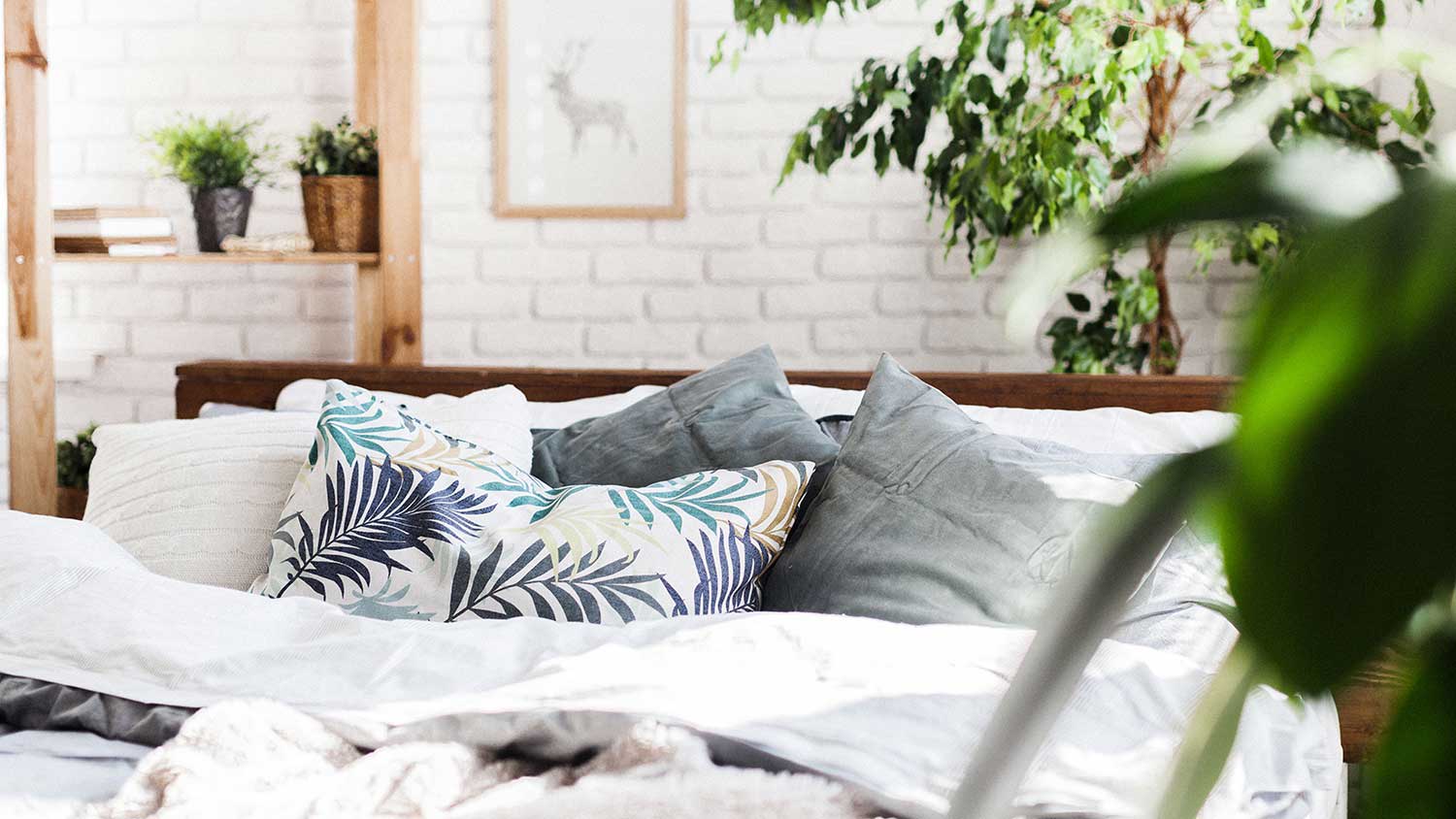 Closeup of a bed with assorted design pillows