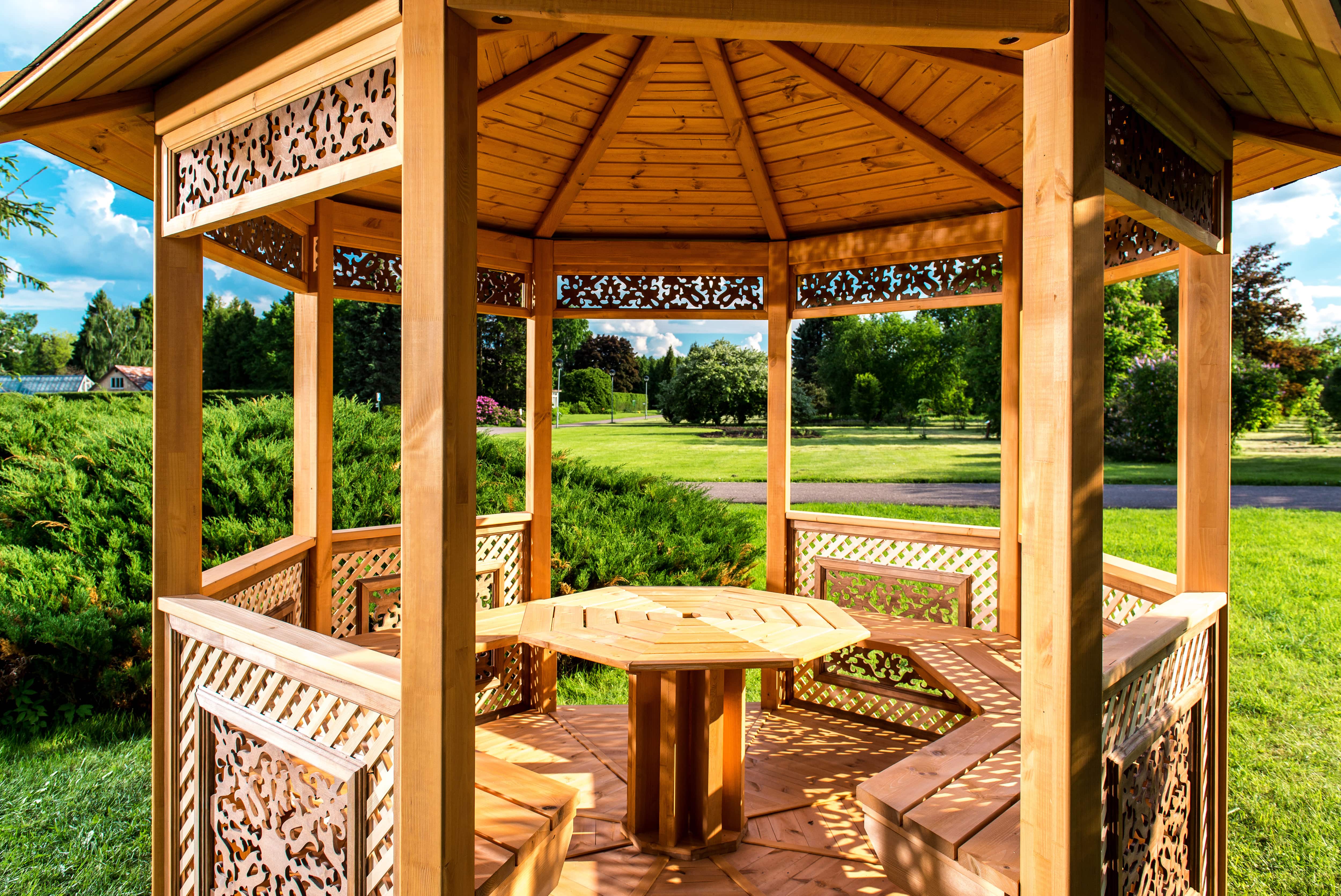 Wooden gazebo with built-in seating and table