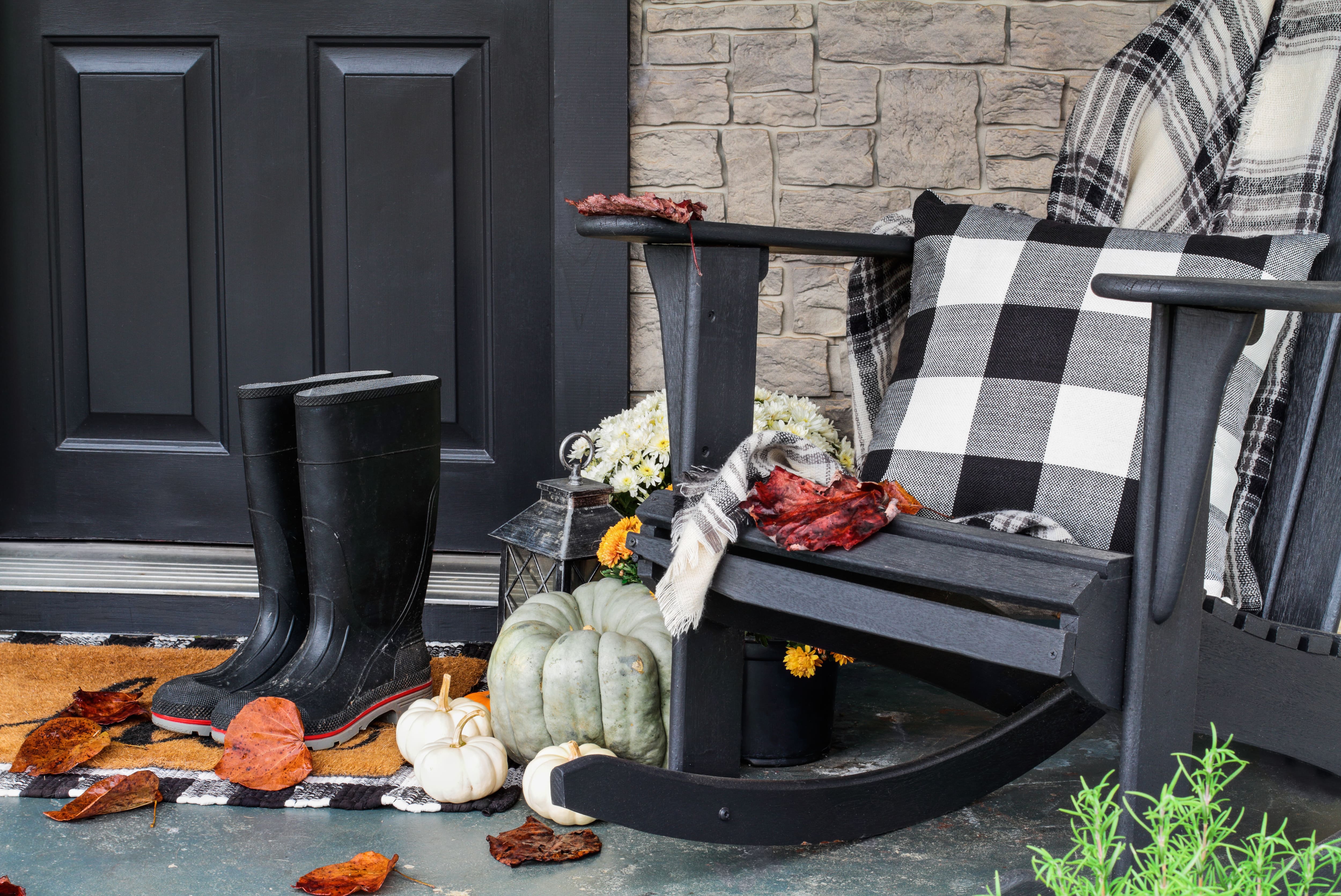 Blanket and throw pillow on rocking chair on porch