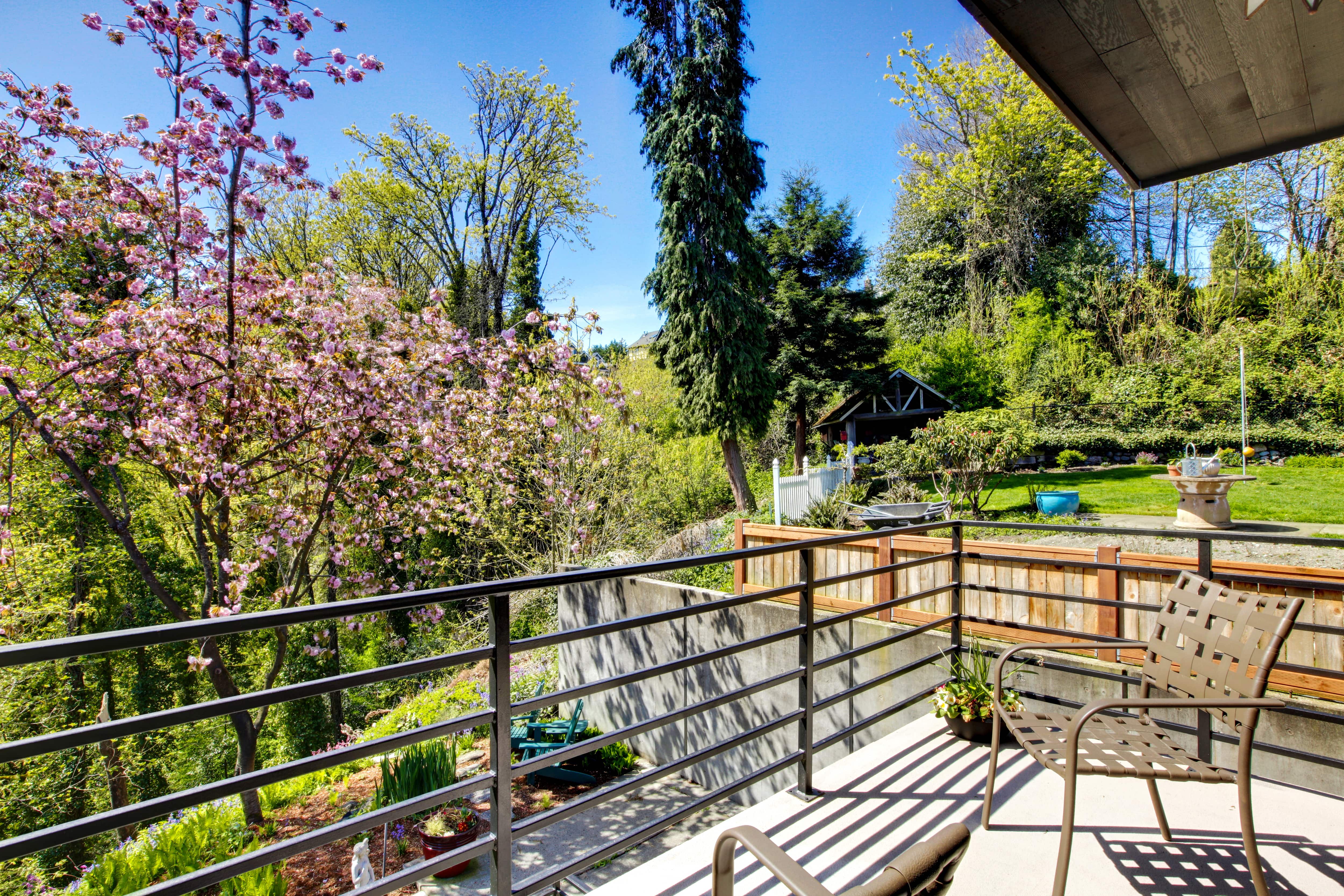 Modern metal horizontal railing along back porch area