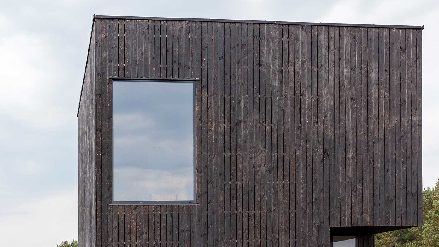 Closeup of a modern house built with wood burning siding
