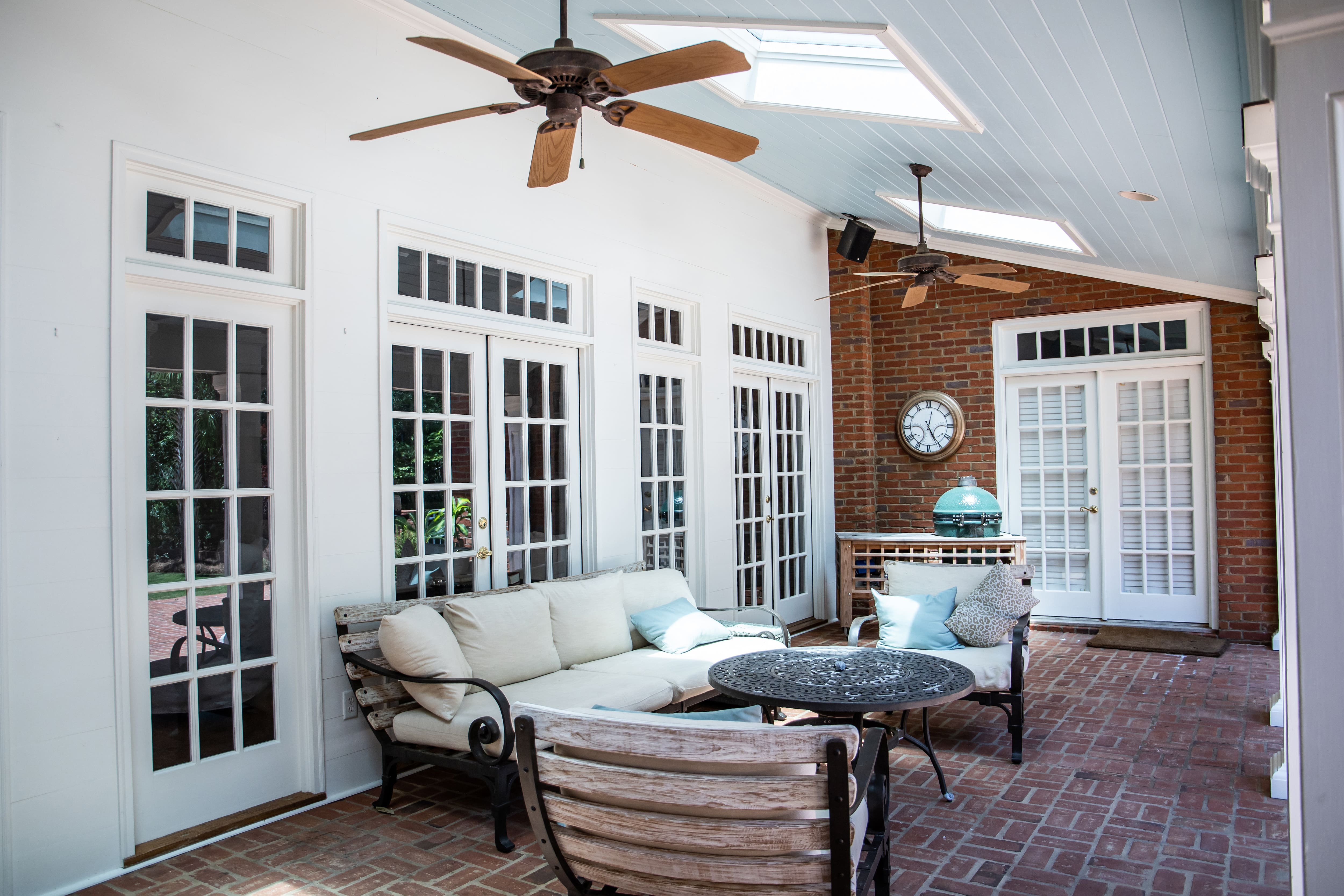 Conversation set in enclosed back porch with ceiling fans