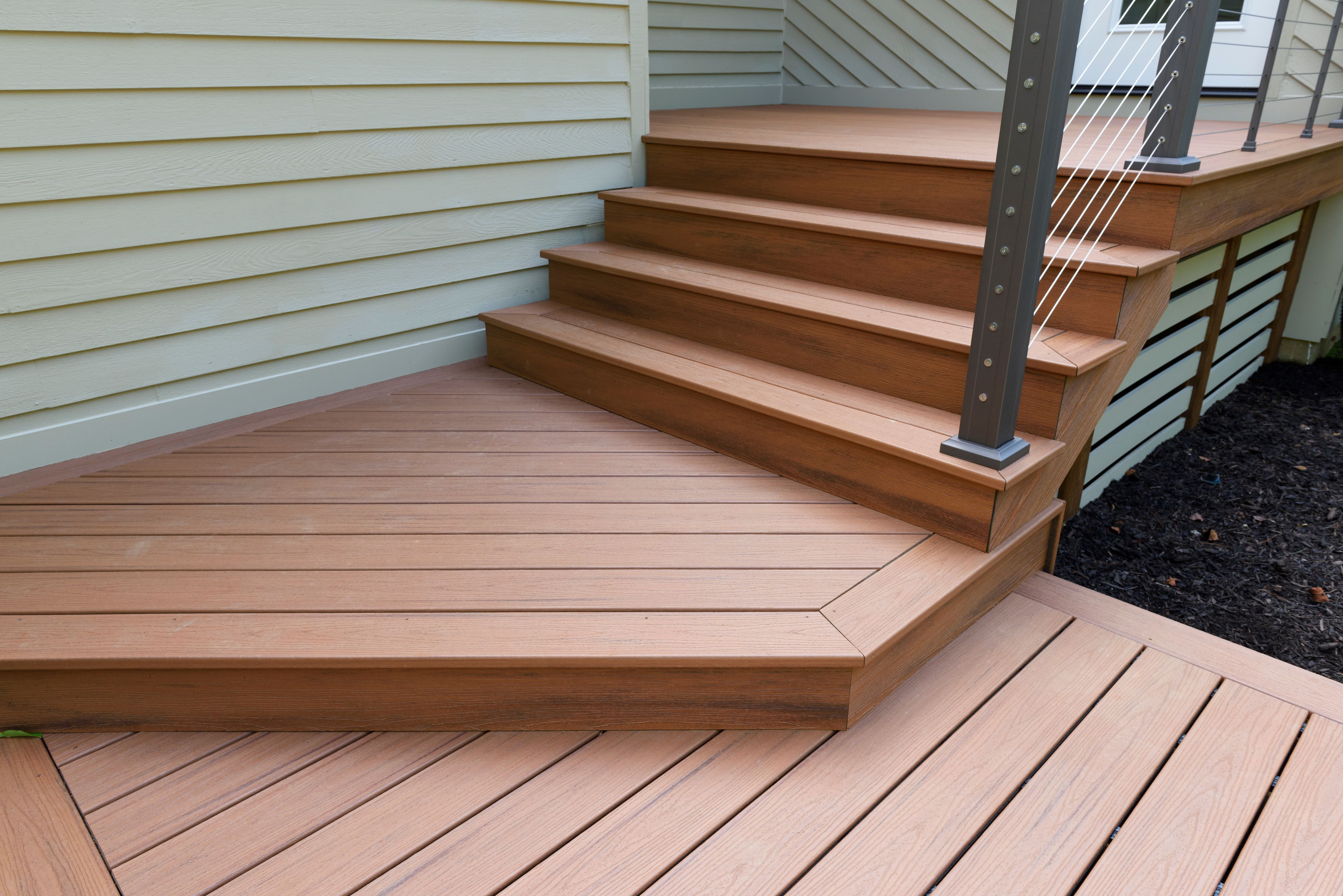 Modern cable railing along deck stairs