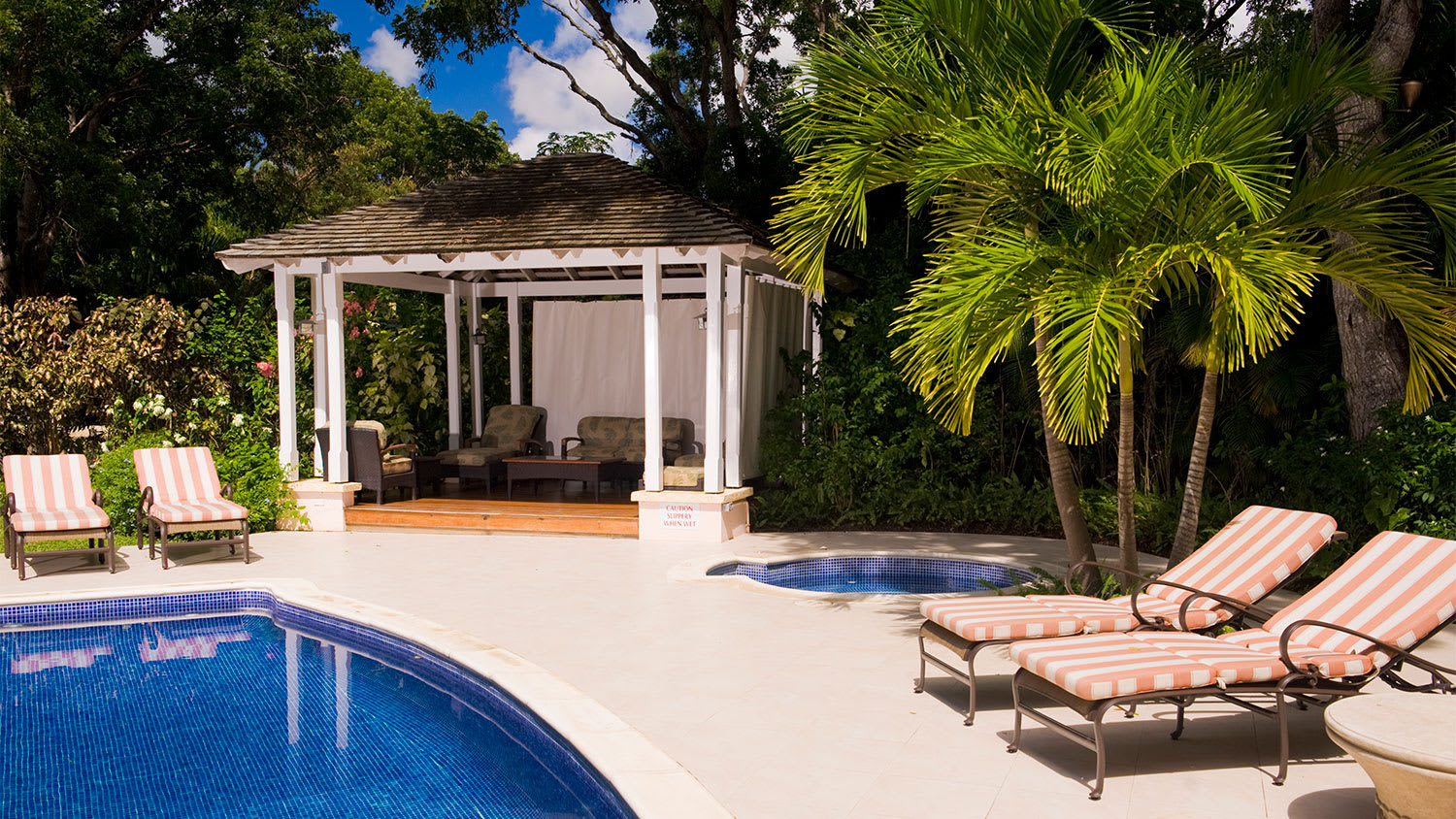 cabana and swimming pool in yard