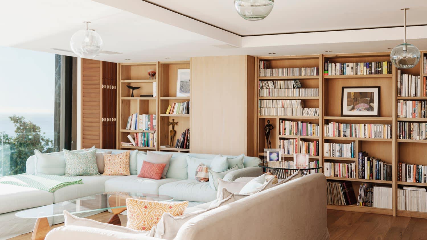 A bright living room with a huge wooden bookcase