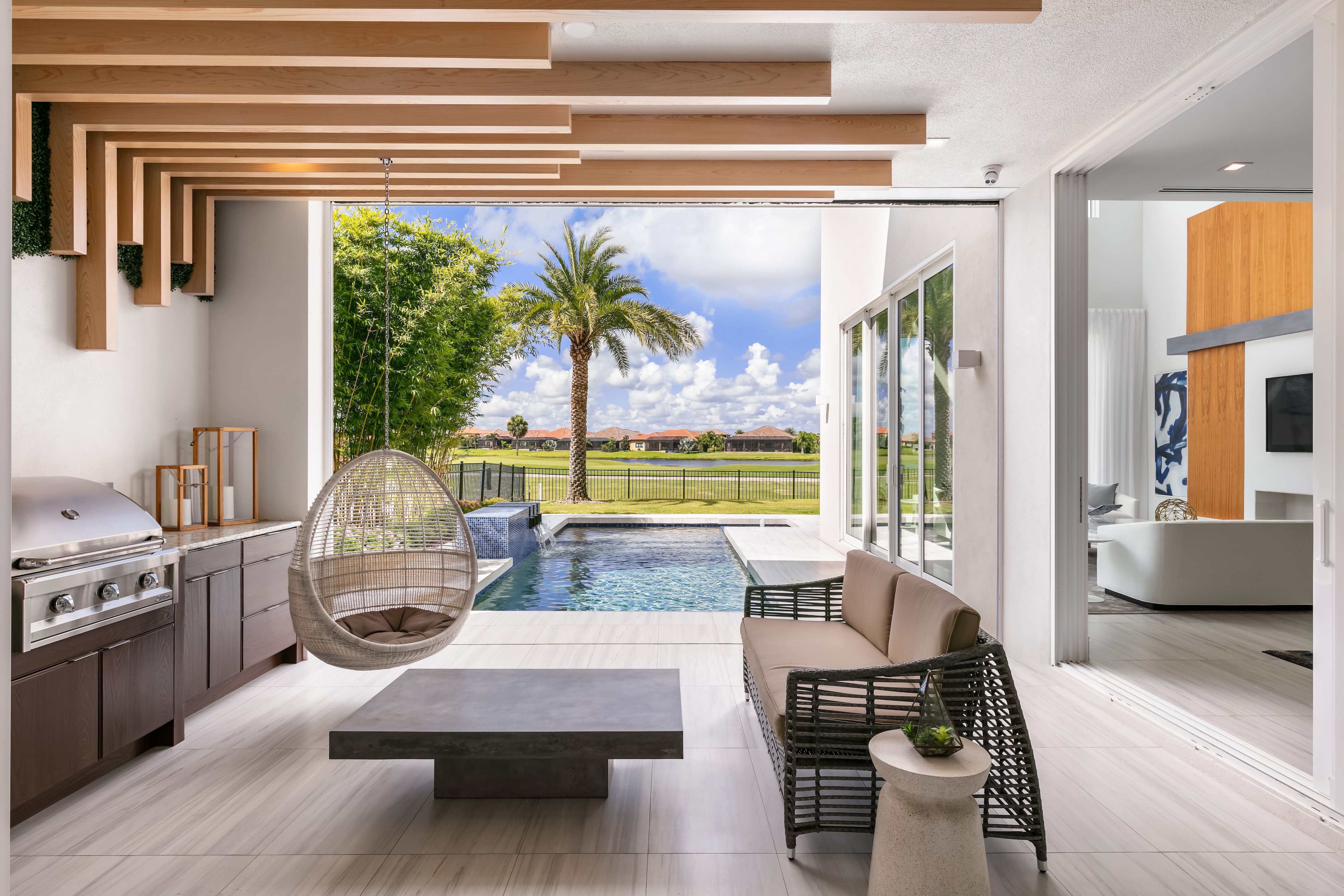 Modern back porch area with living room and outdoor kitchen