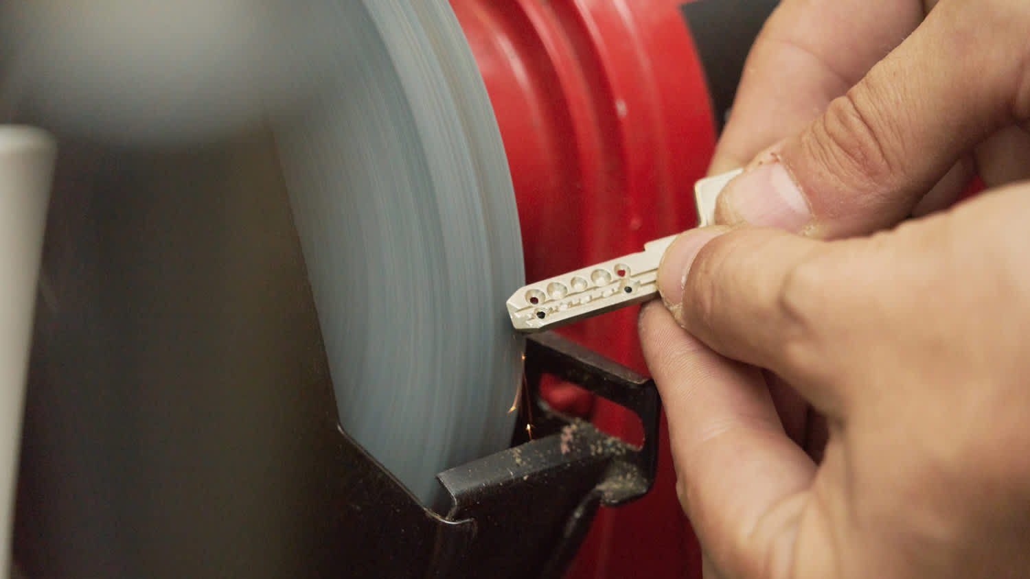Close-up of a blacksmith’s hand duplicating a door key