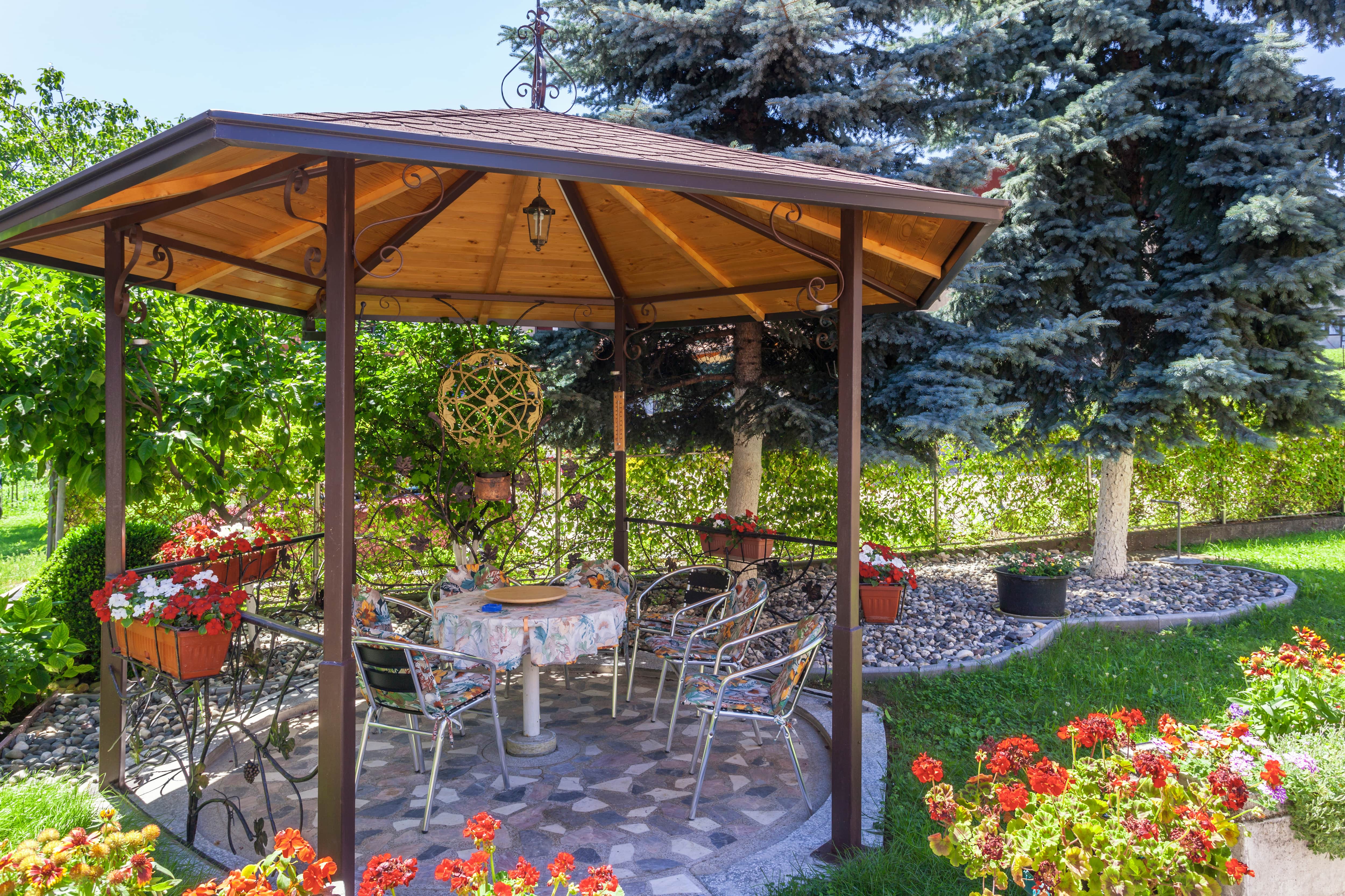 Metal gazebo in yard with ornamental decorations