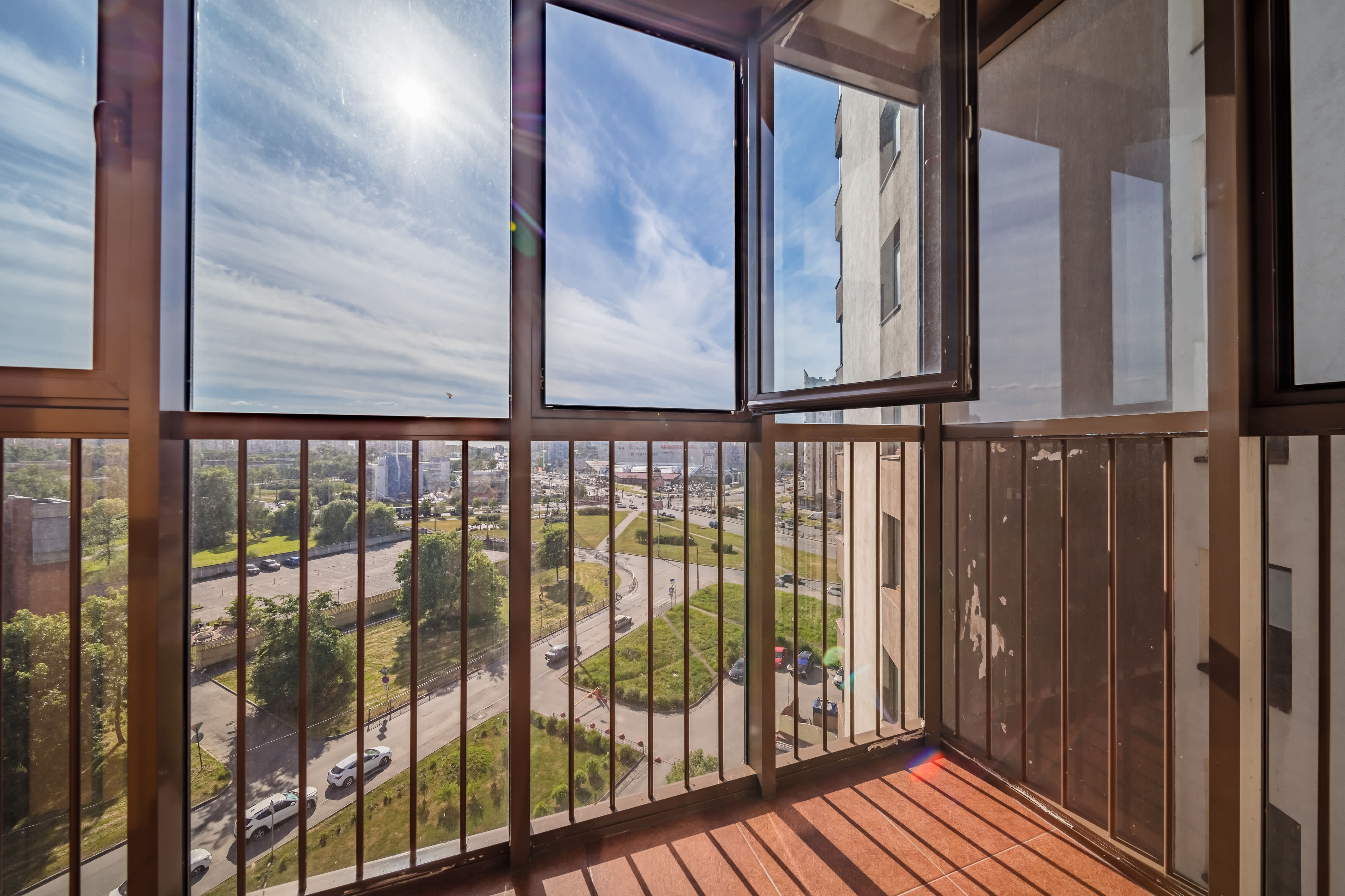 Enclosed small balcony with open windows