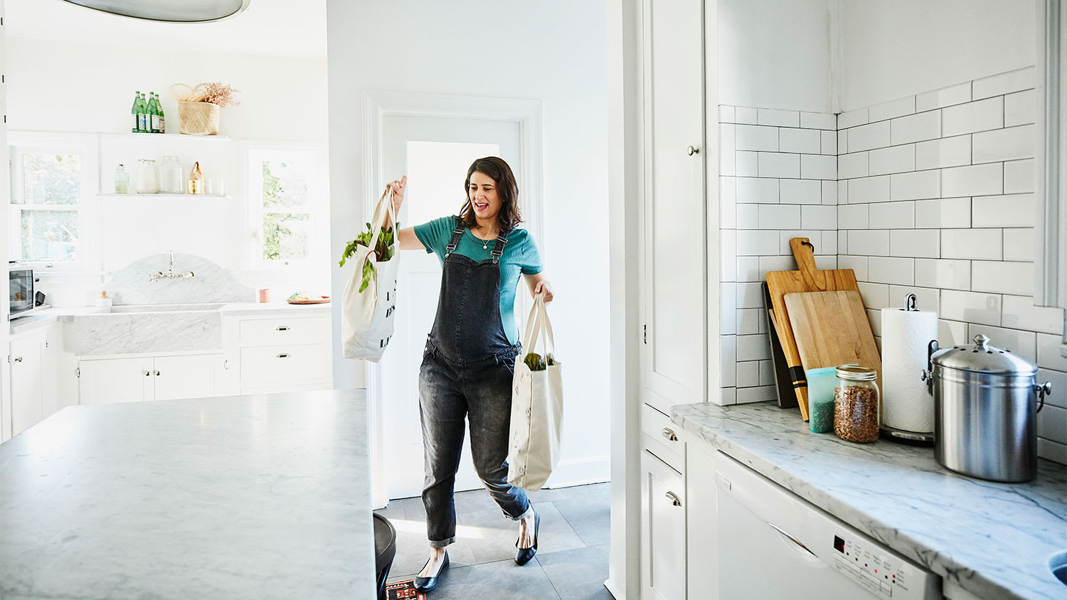 A woman brings groceries home