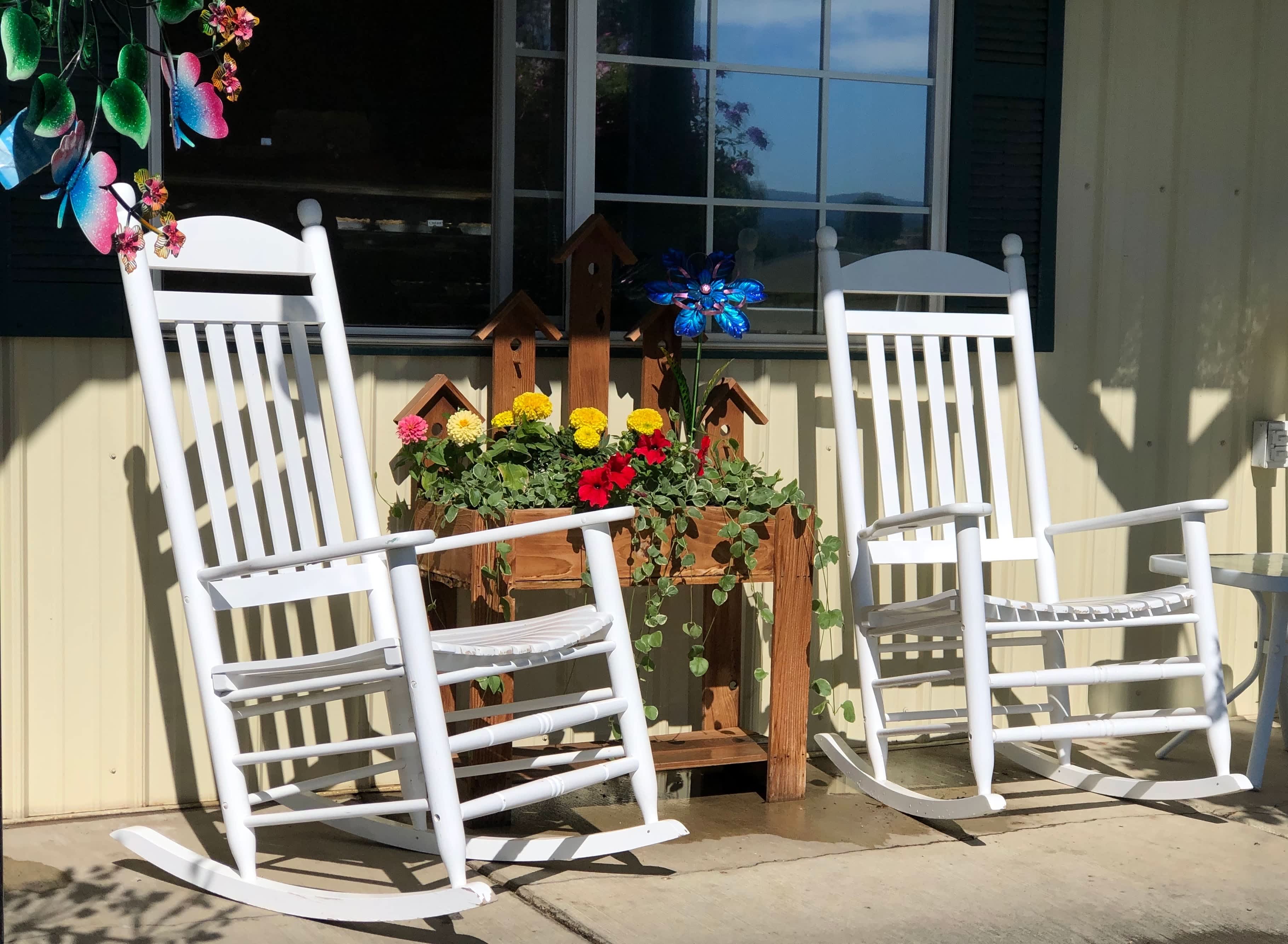 Stand-up planter next to rocking chairs on porch