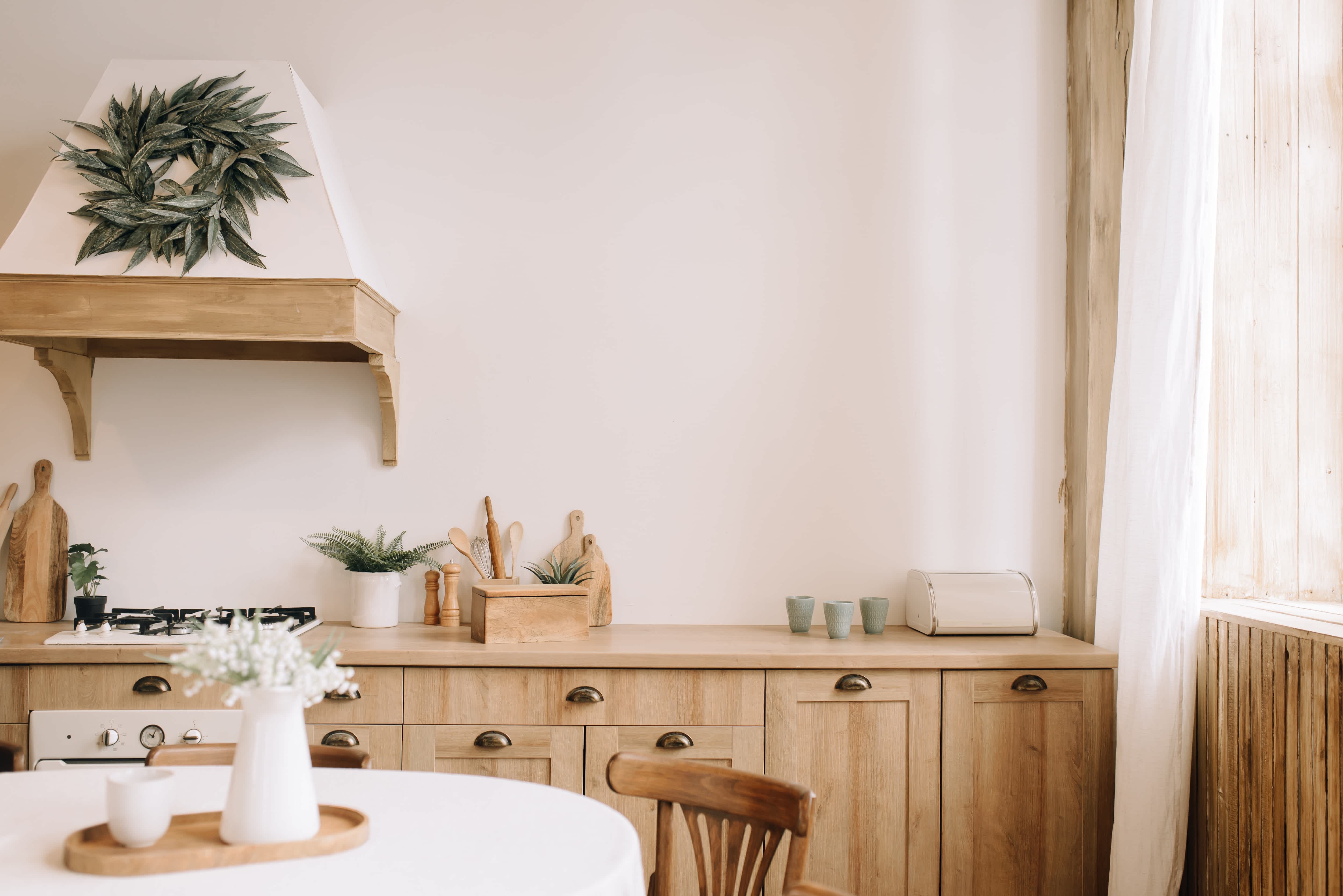 Light wood cabinetry in boho kitchen