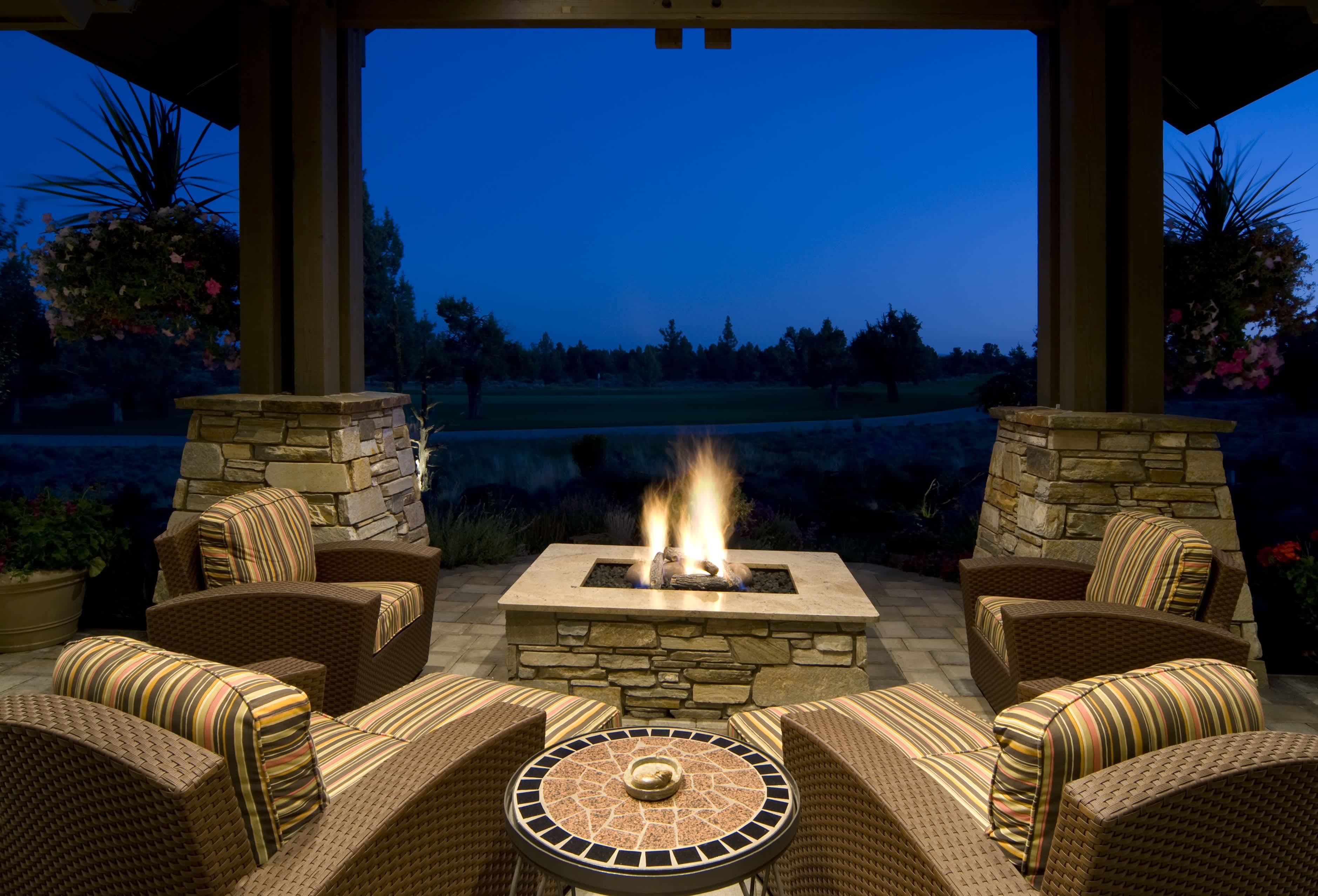 Outdoor swivel chairs placed around fire pit
