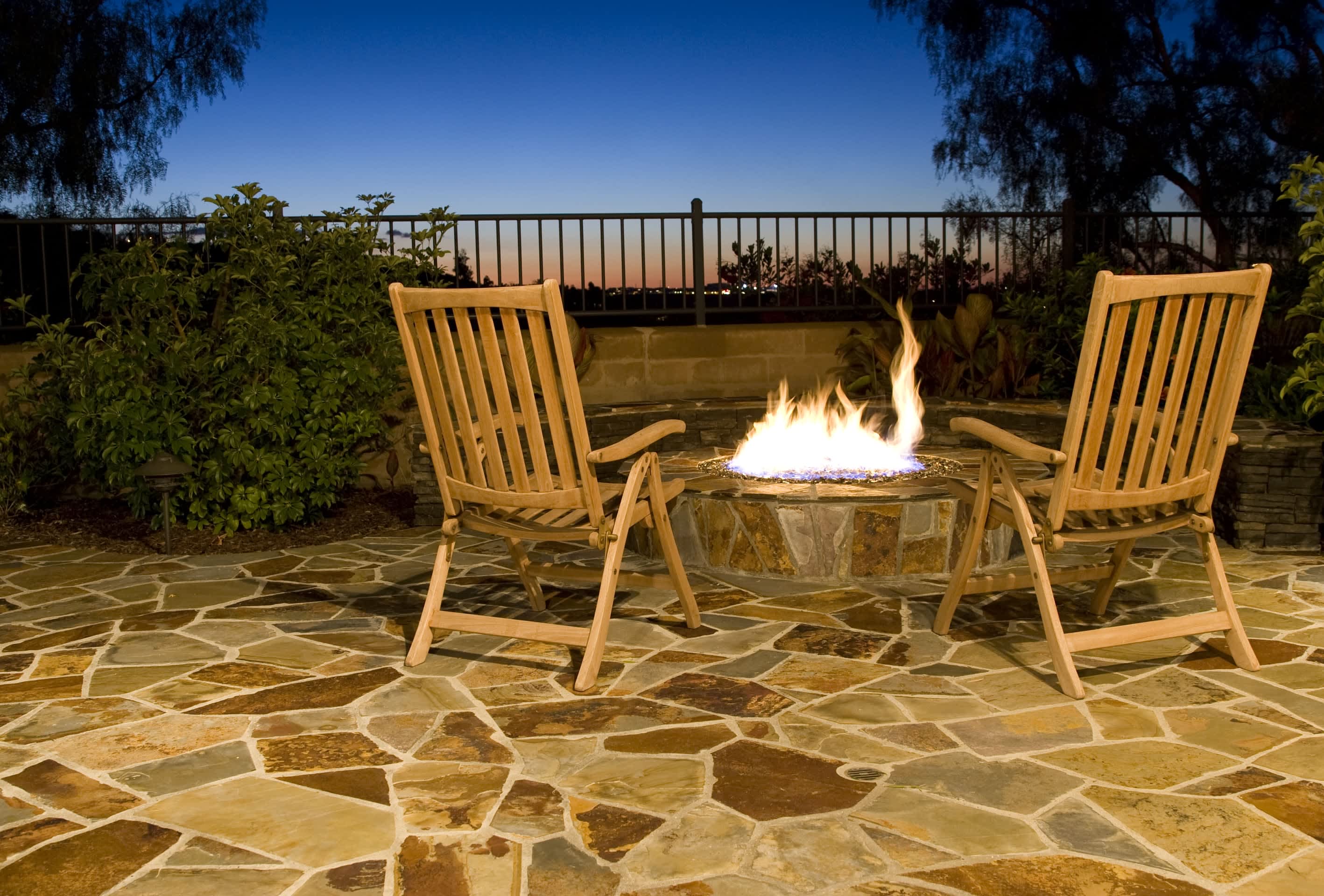 Fold-up wooden chairs over flagstone patio