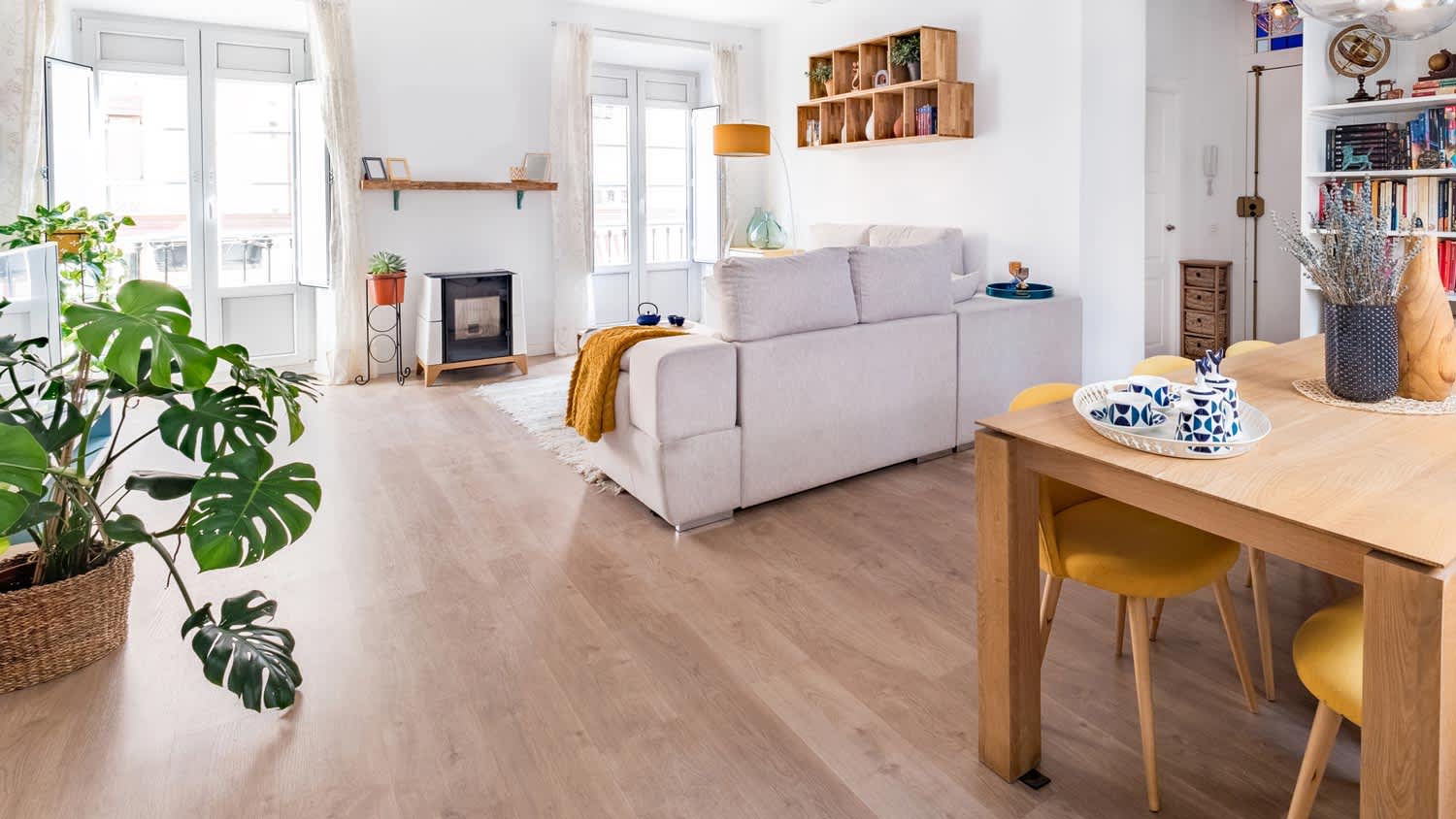 A cozy living room with a sofa and a wooden table