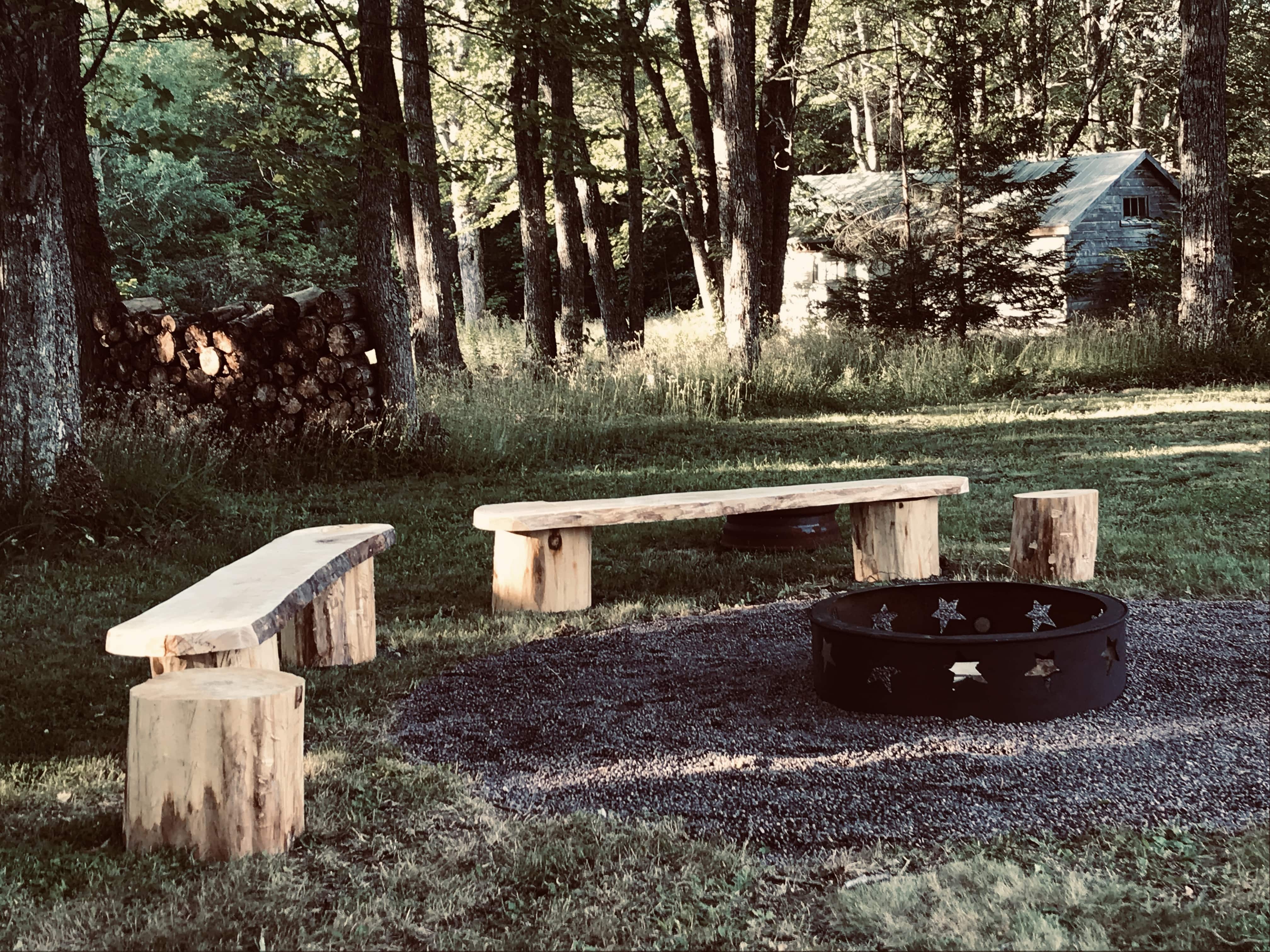 Fire pit bench seating created using tree stump and wood