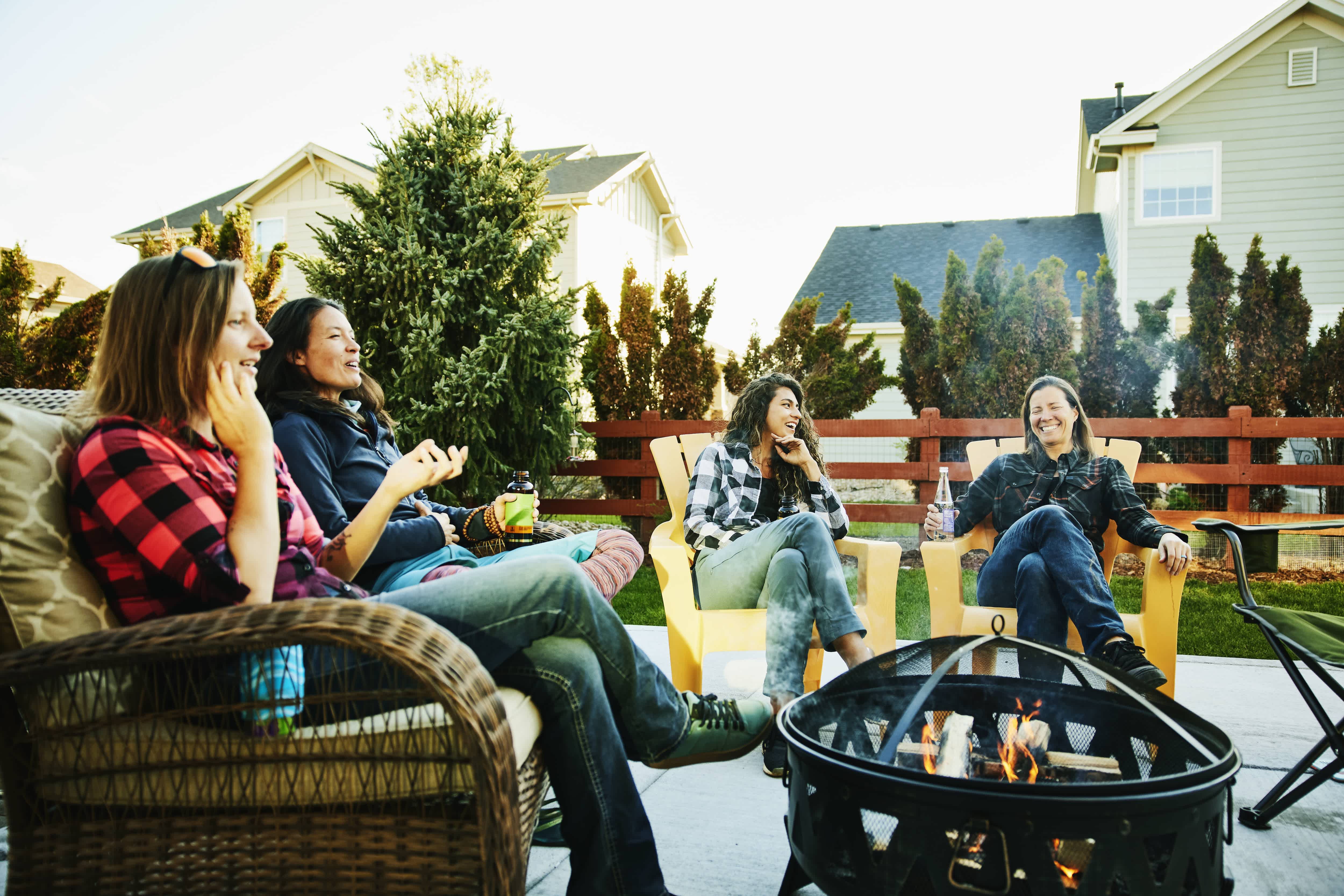 Group of friends sitting around fire pit