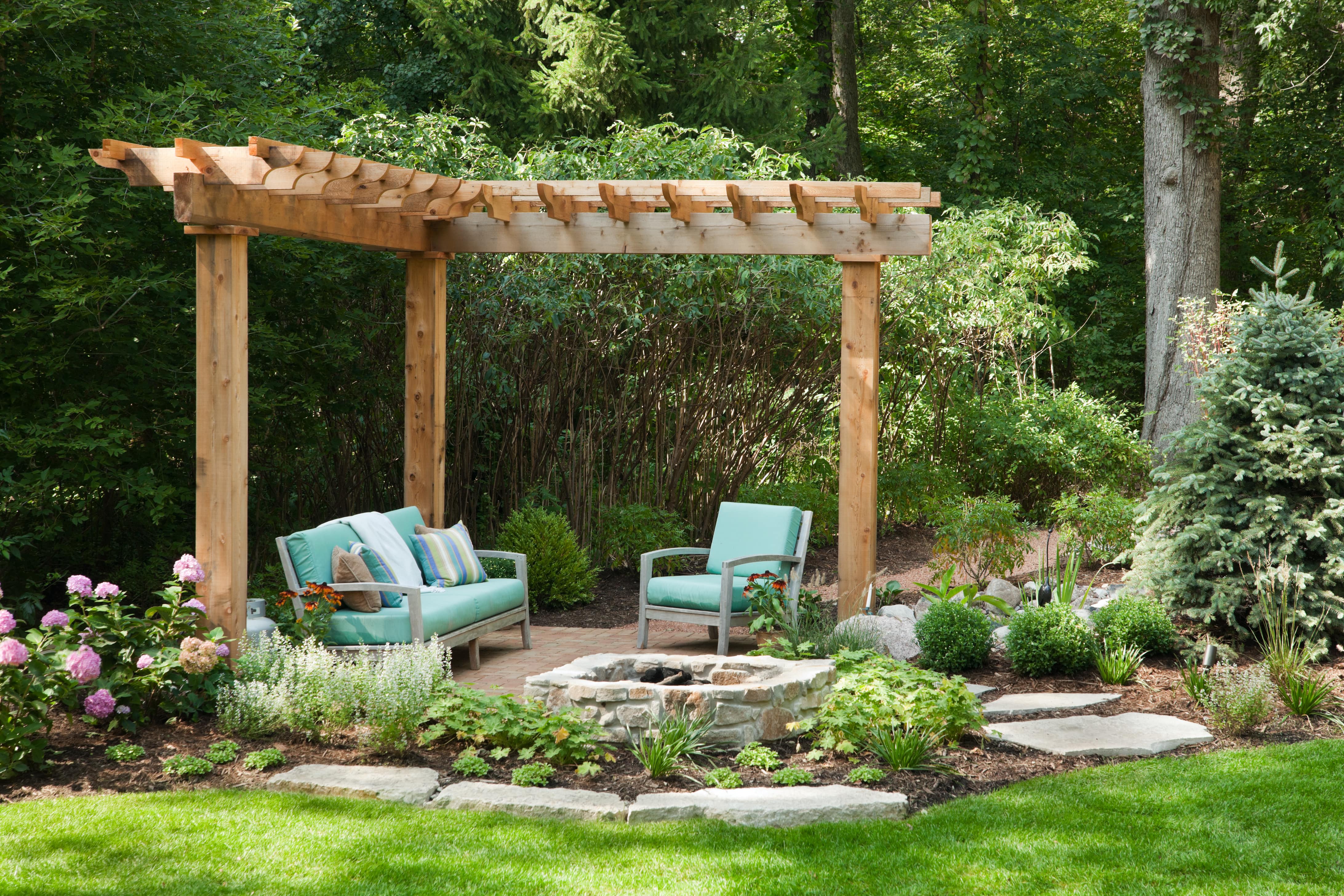 Teal outdoor conversation set under wooden pergola