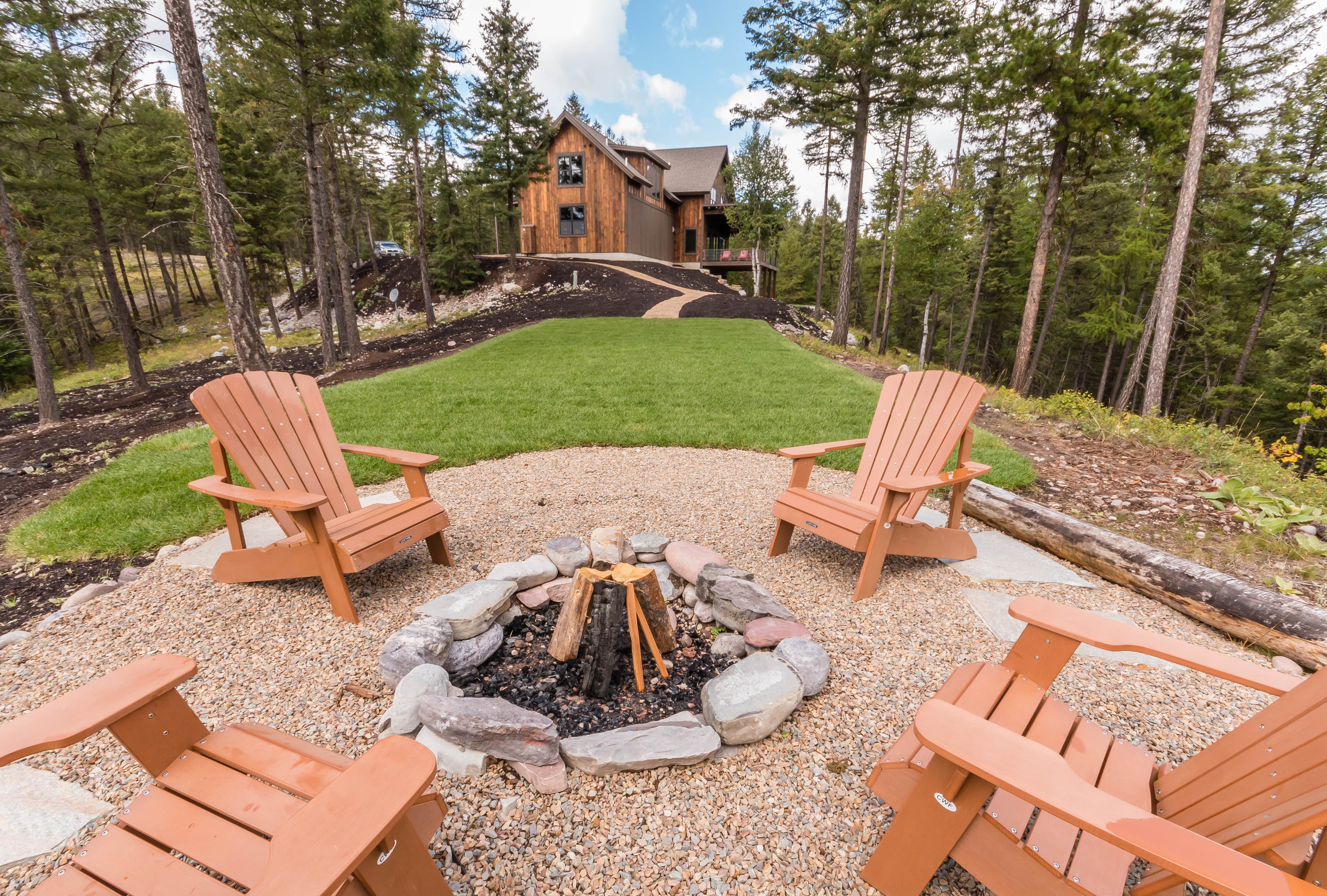 Wooden Adirondack chairs surrounding fire pit