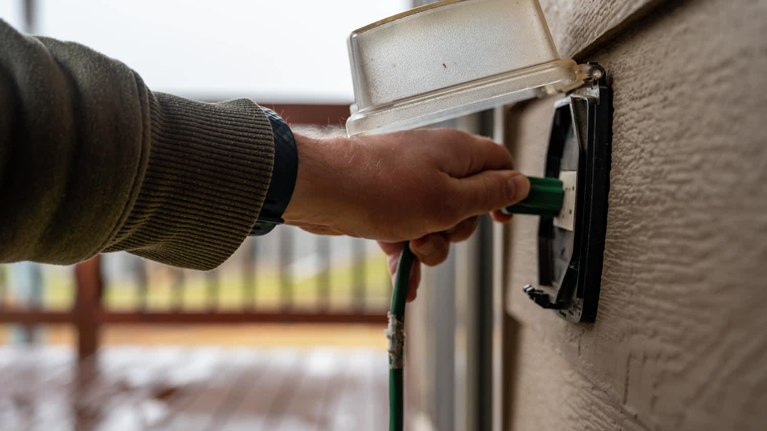 A man gripping power cord